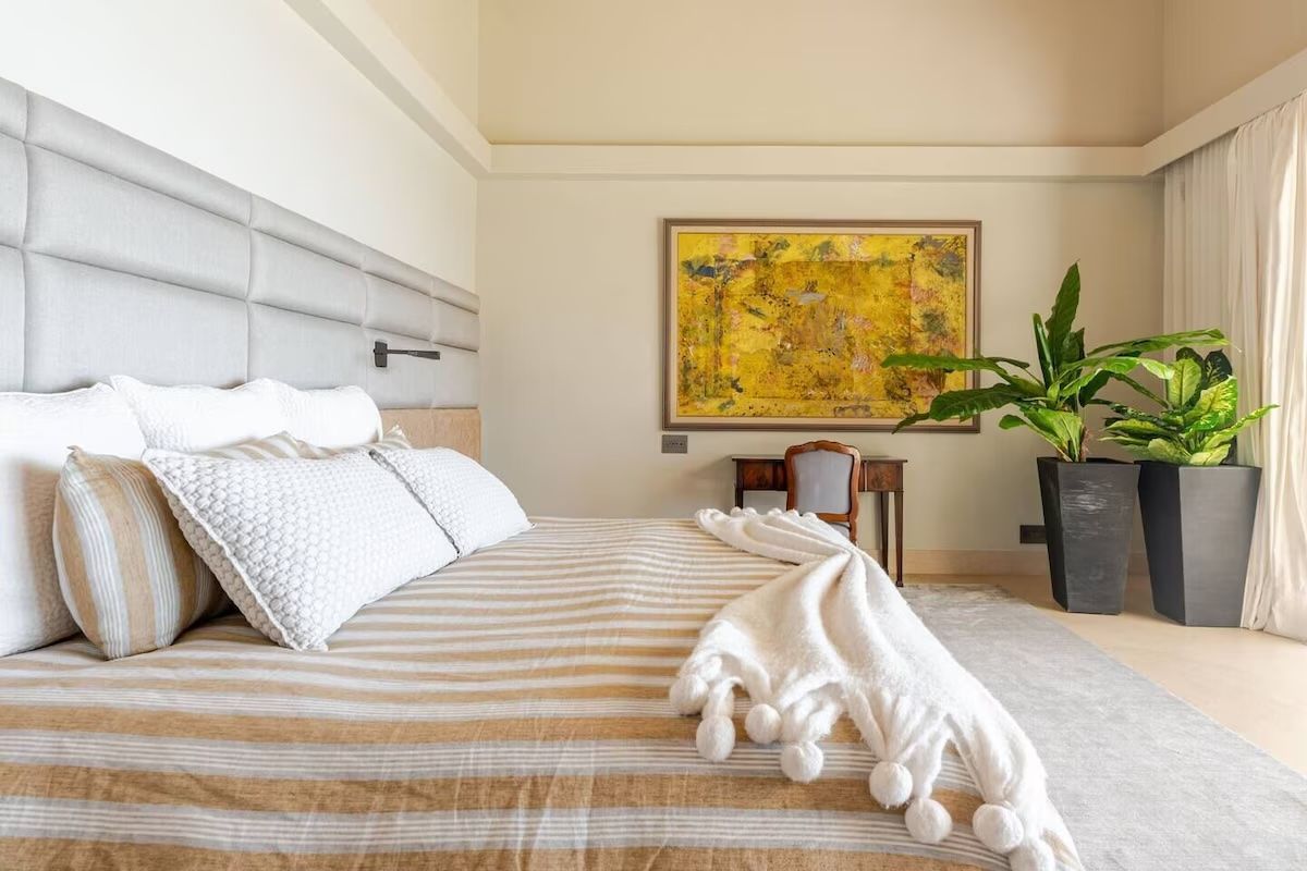a bedroom with a large flat screen tv on the wall