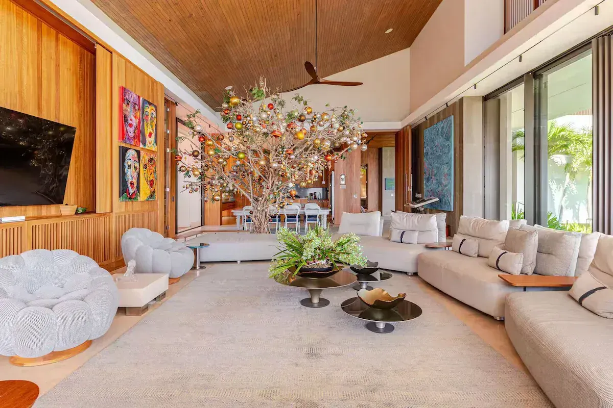 a living room with white furniture and a flat screen tv