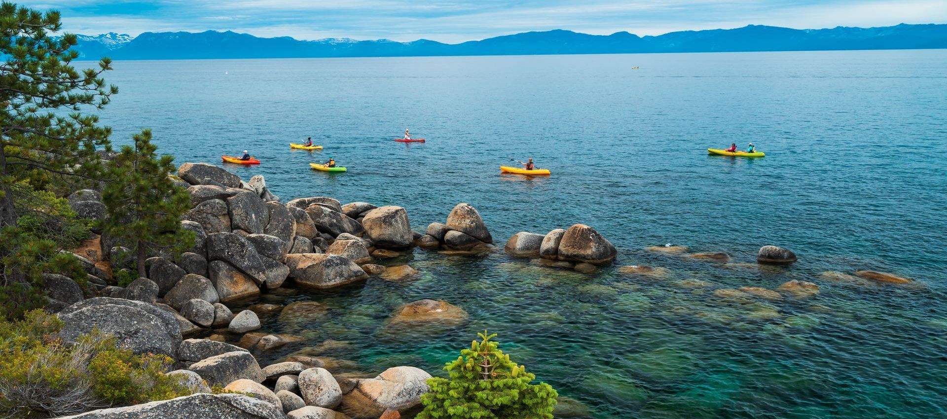 A group of people are kayaking on a lake.