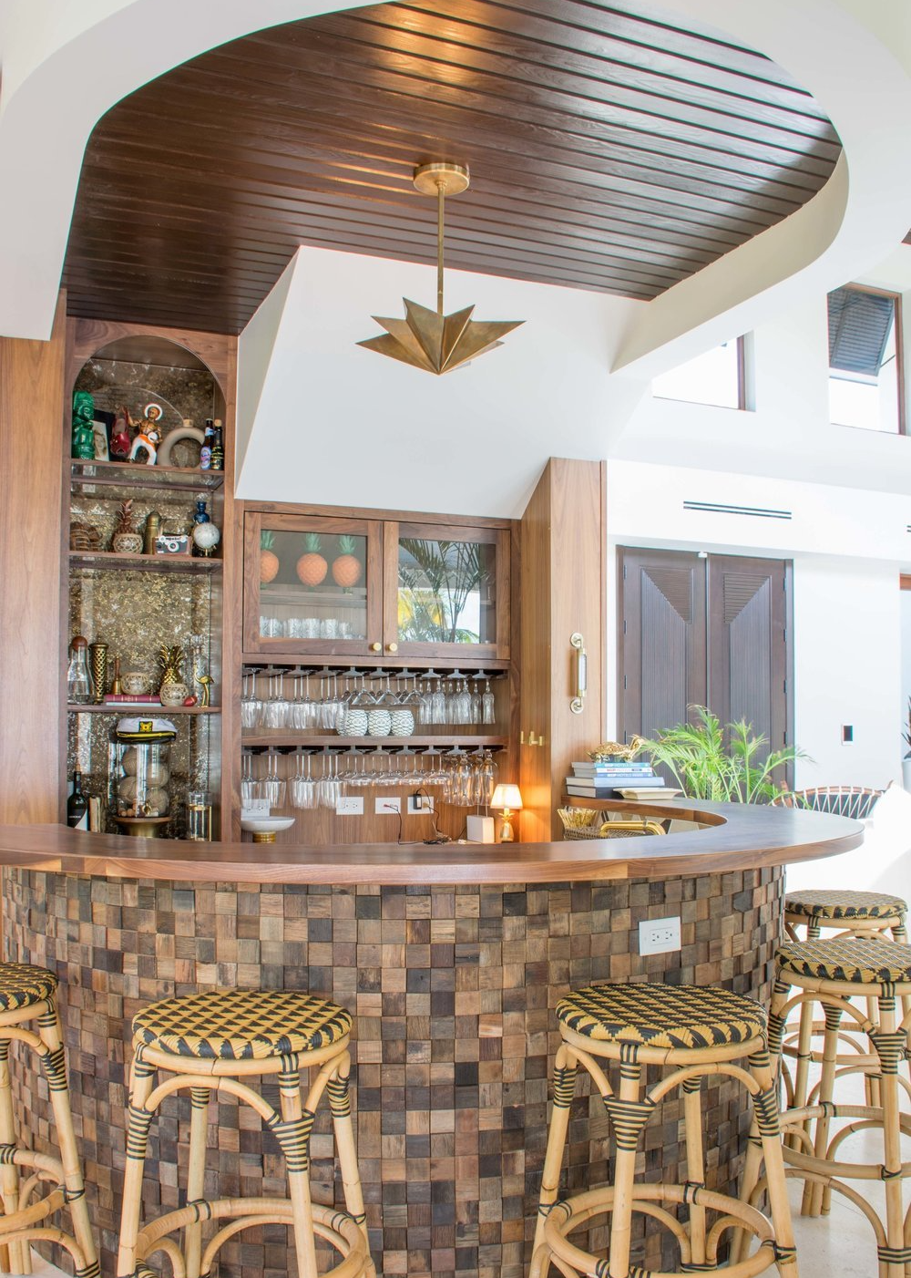 a bar with stools and a wine rack in a living room