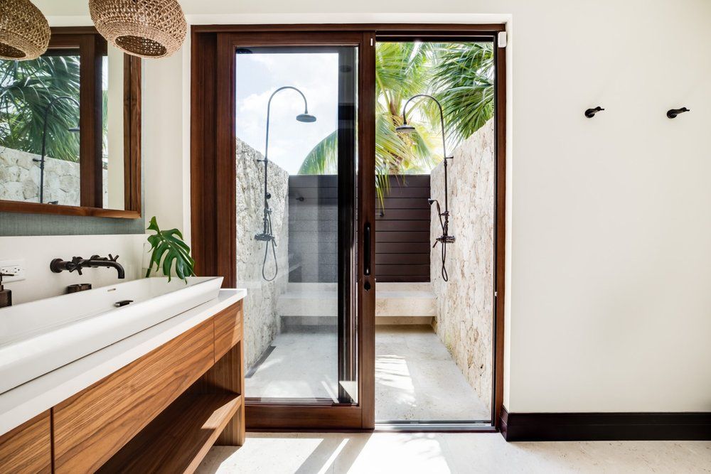 a bathroom with a sliding glass door leading to a shower