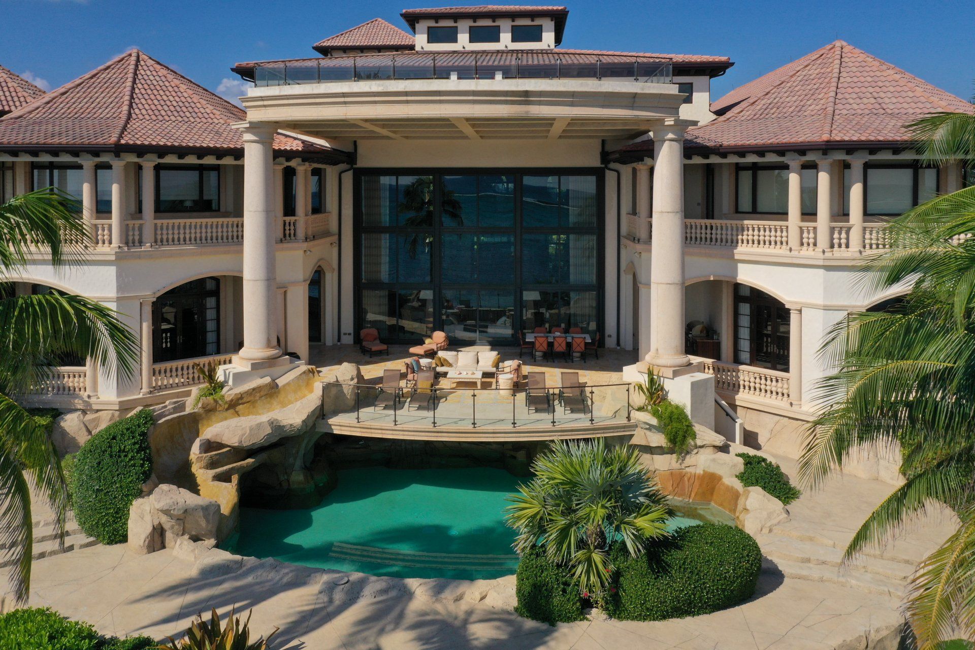 a large house with a swimming pool in front of it