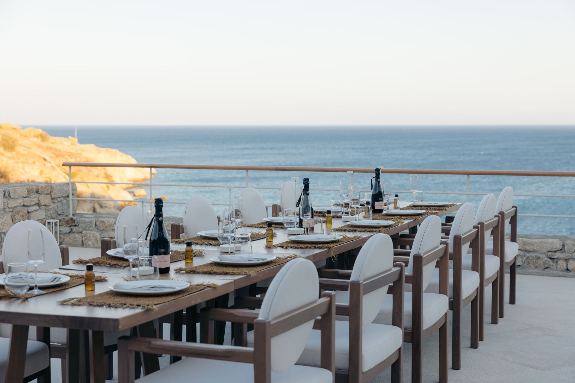 a restaurant with tables and chairs overlooking the ocean