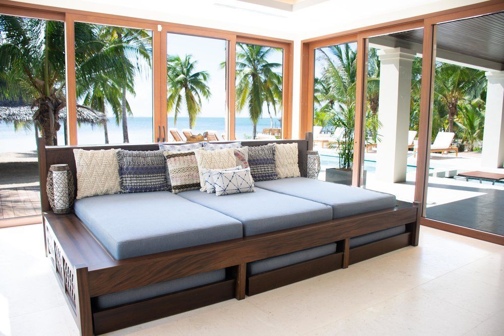 a couch in a living room with a view of the ocean