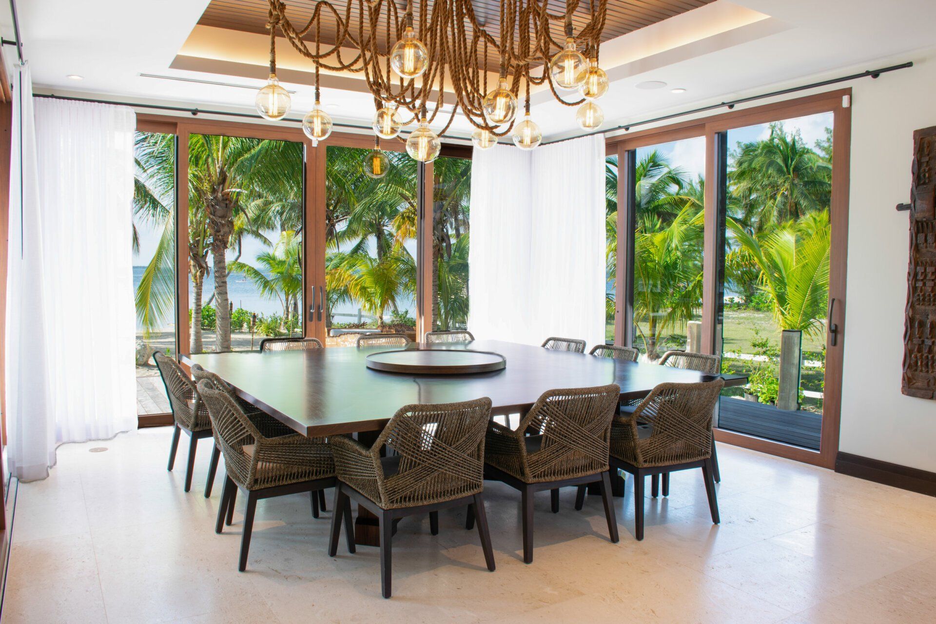 a dining room with a large table and chairs and a chandelier