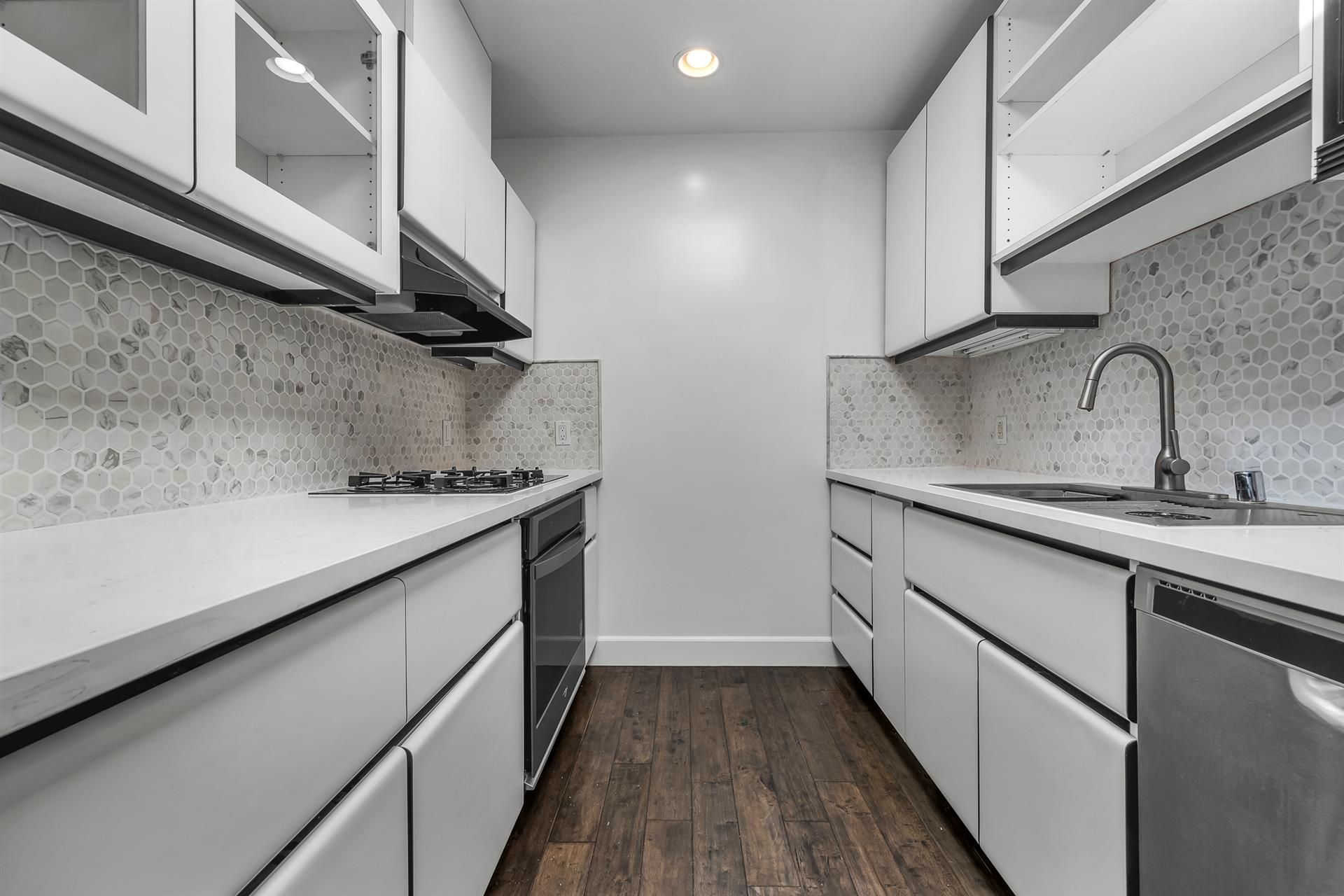 a large kitchen with wooden cabinets and stainless steel appliances