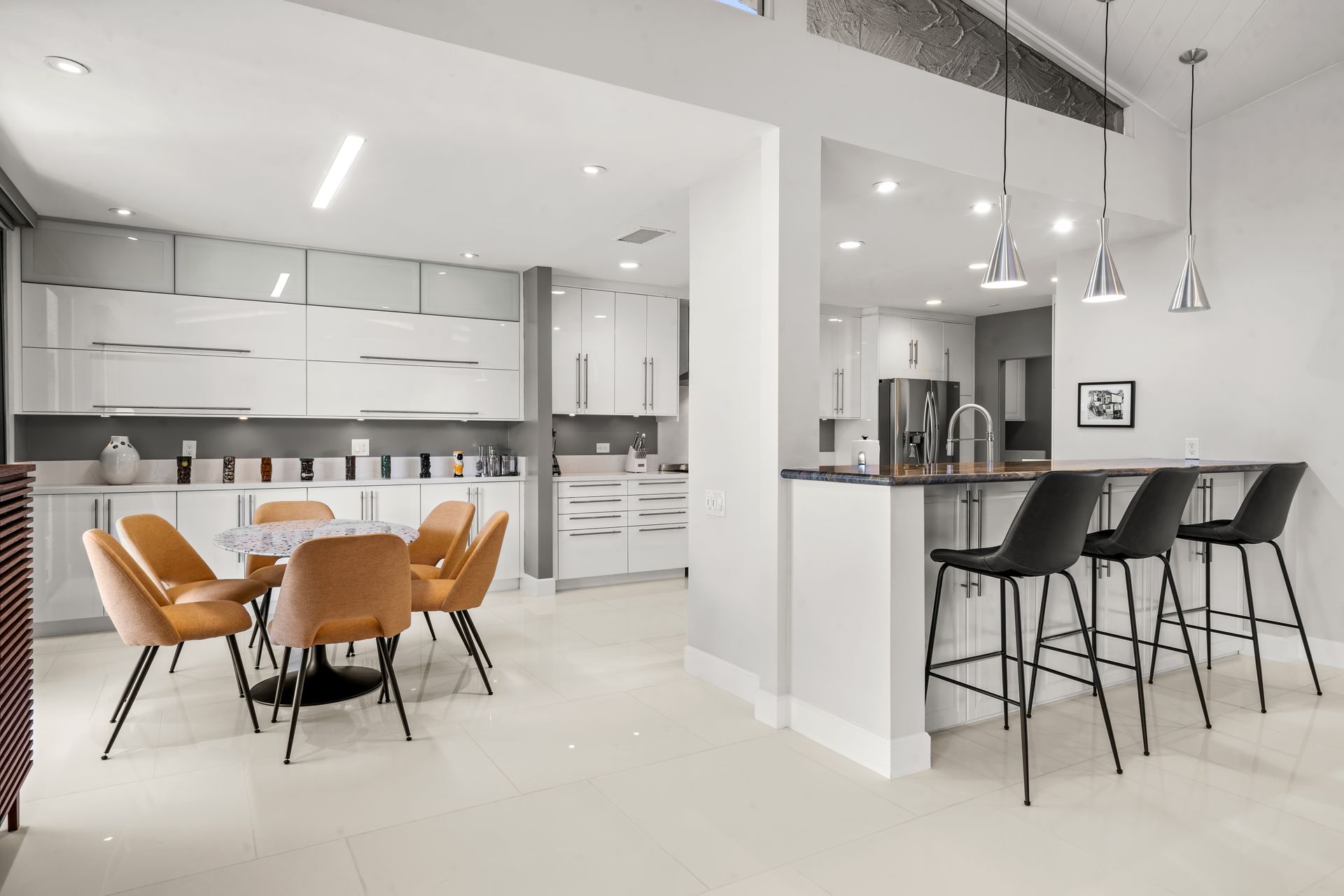 a kitchen and dining room in a house with a table and chairs