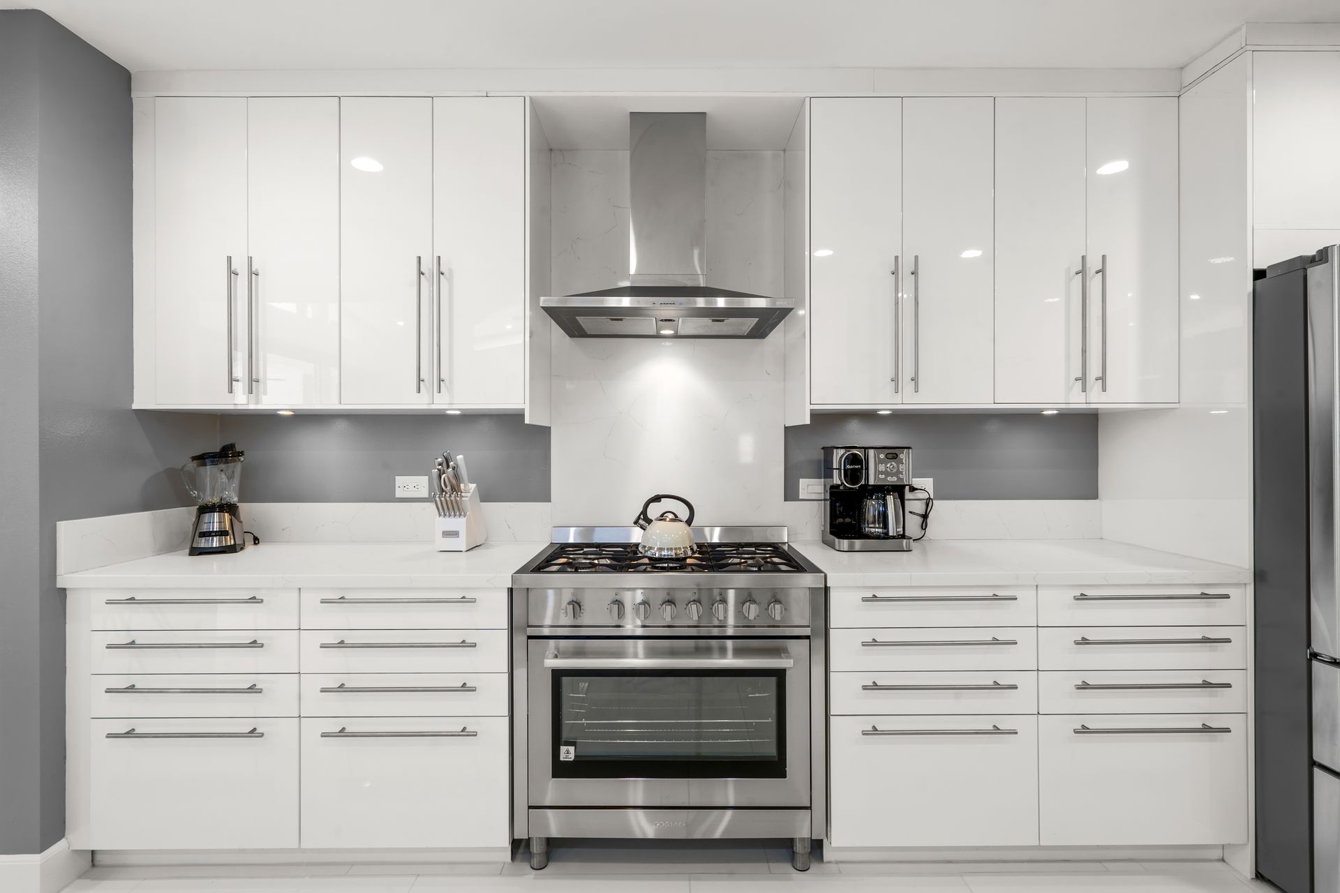 a kitchen with stainless steel appliances and white cabinets