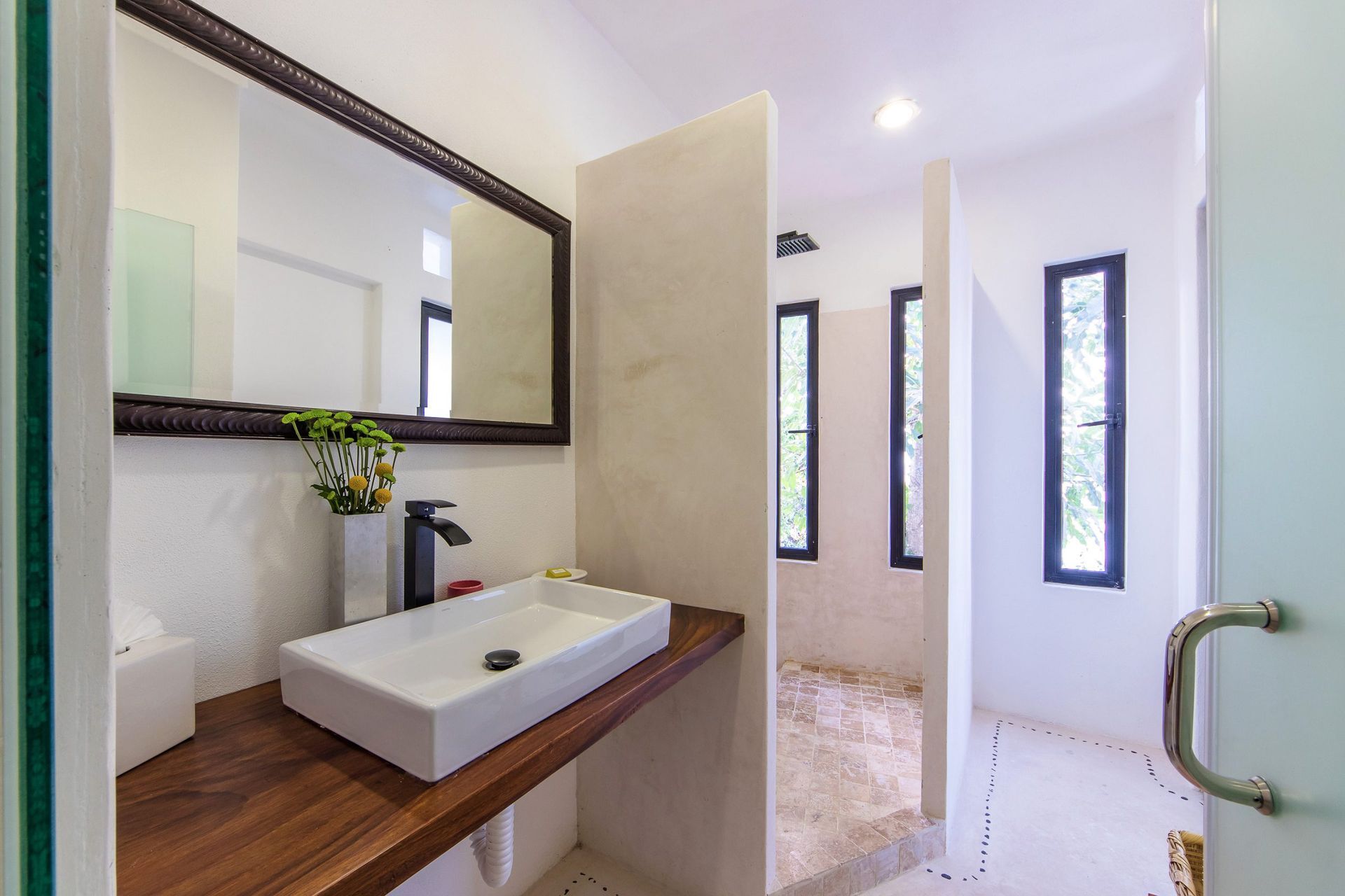 a bathroom with a sink, mirror, and wooden counter top