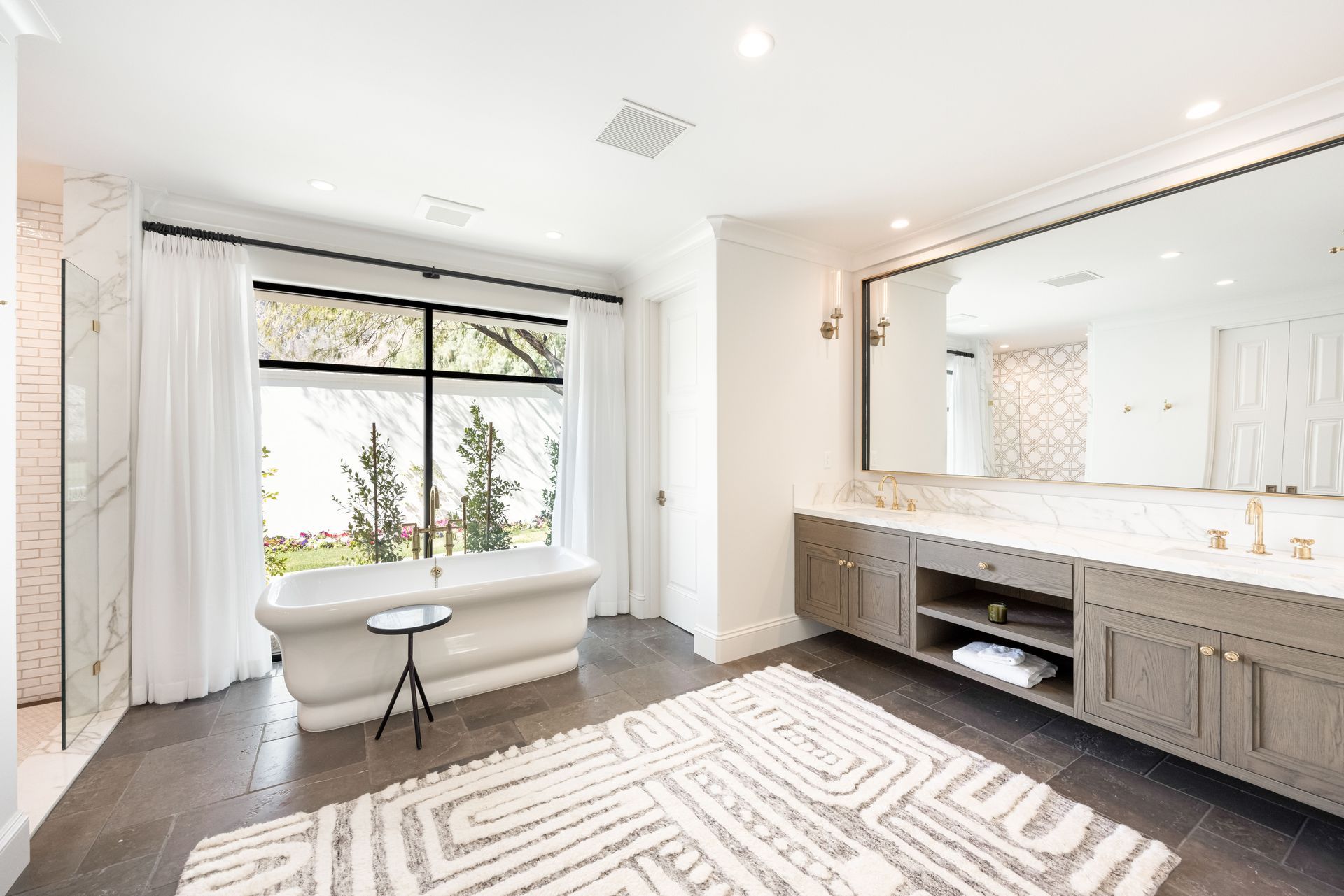 a living room with a couch and chairs and a sliding barn door