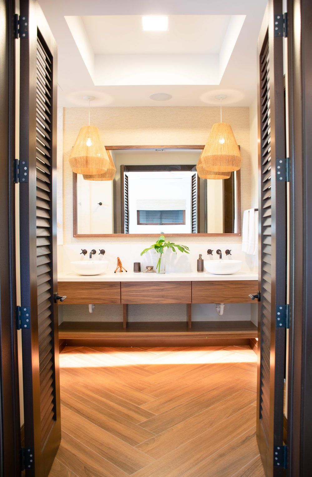 a bathroom with two sinks and a large mirror