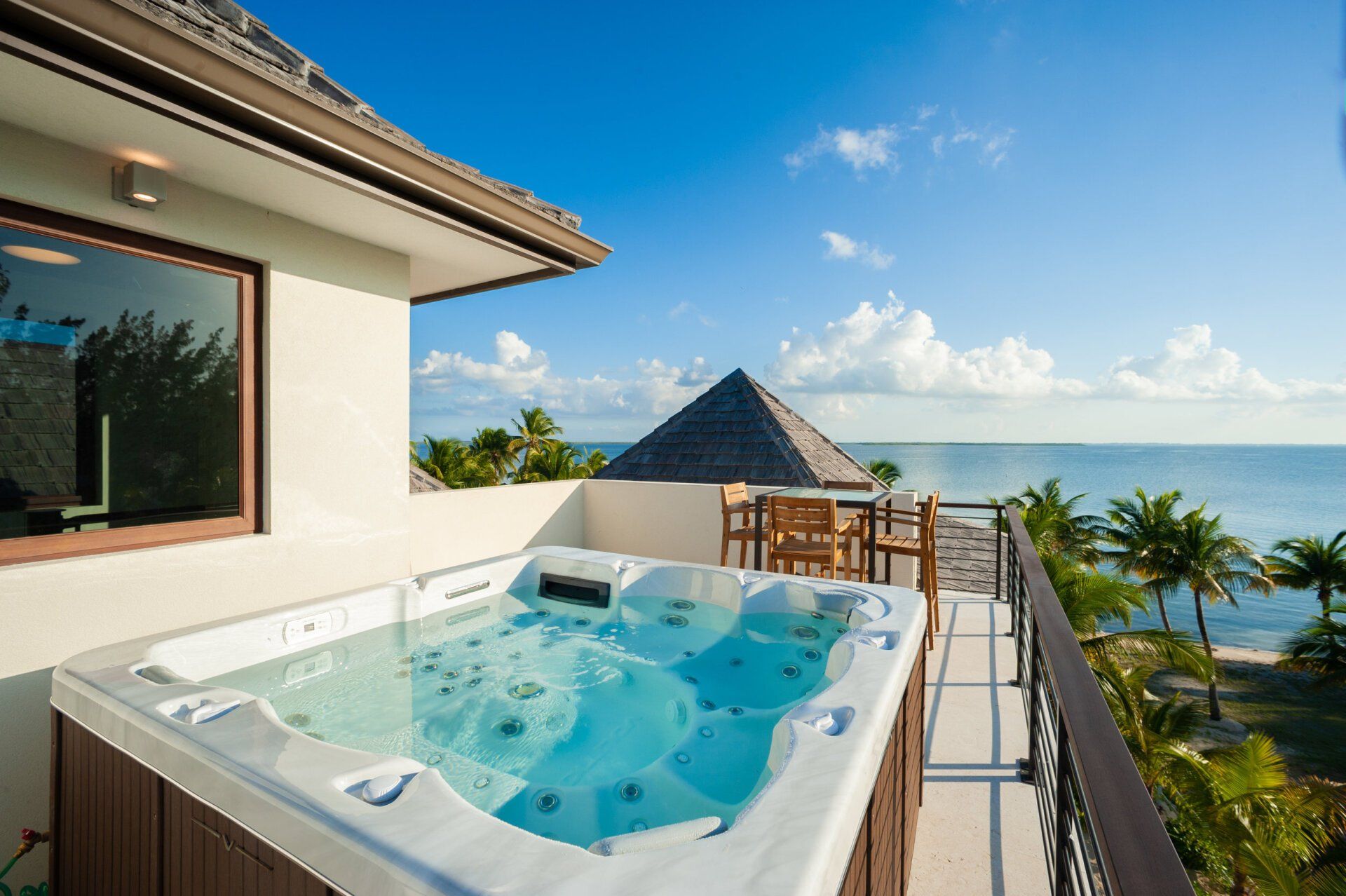 a hot tub on a balcony overlooking the ocean