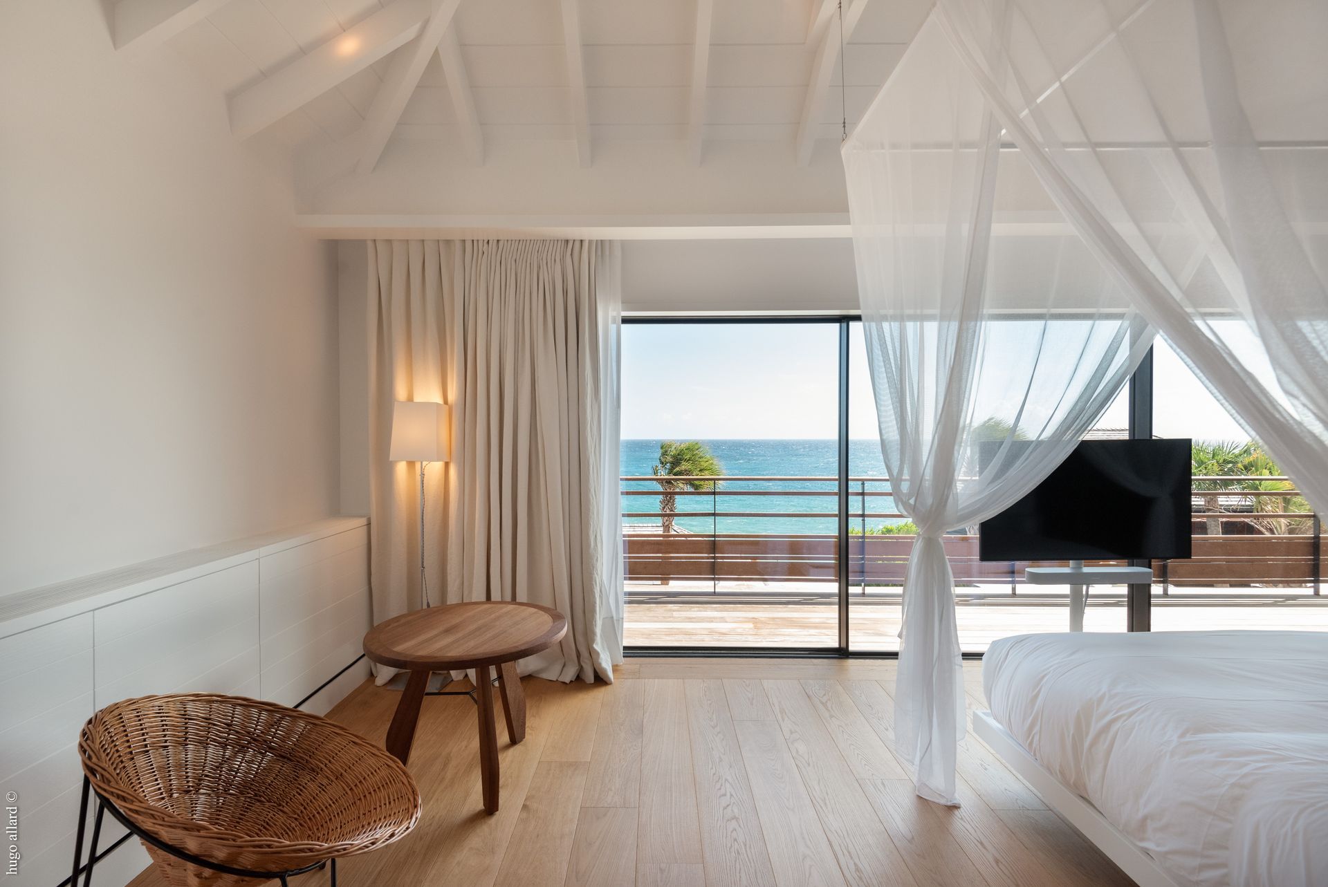 a bedroom with a canopy bed and a view of the ocean