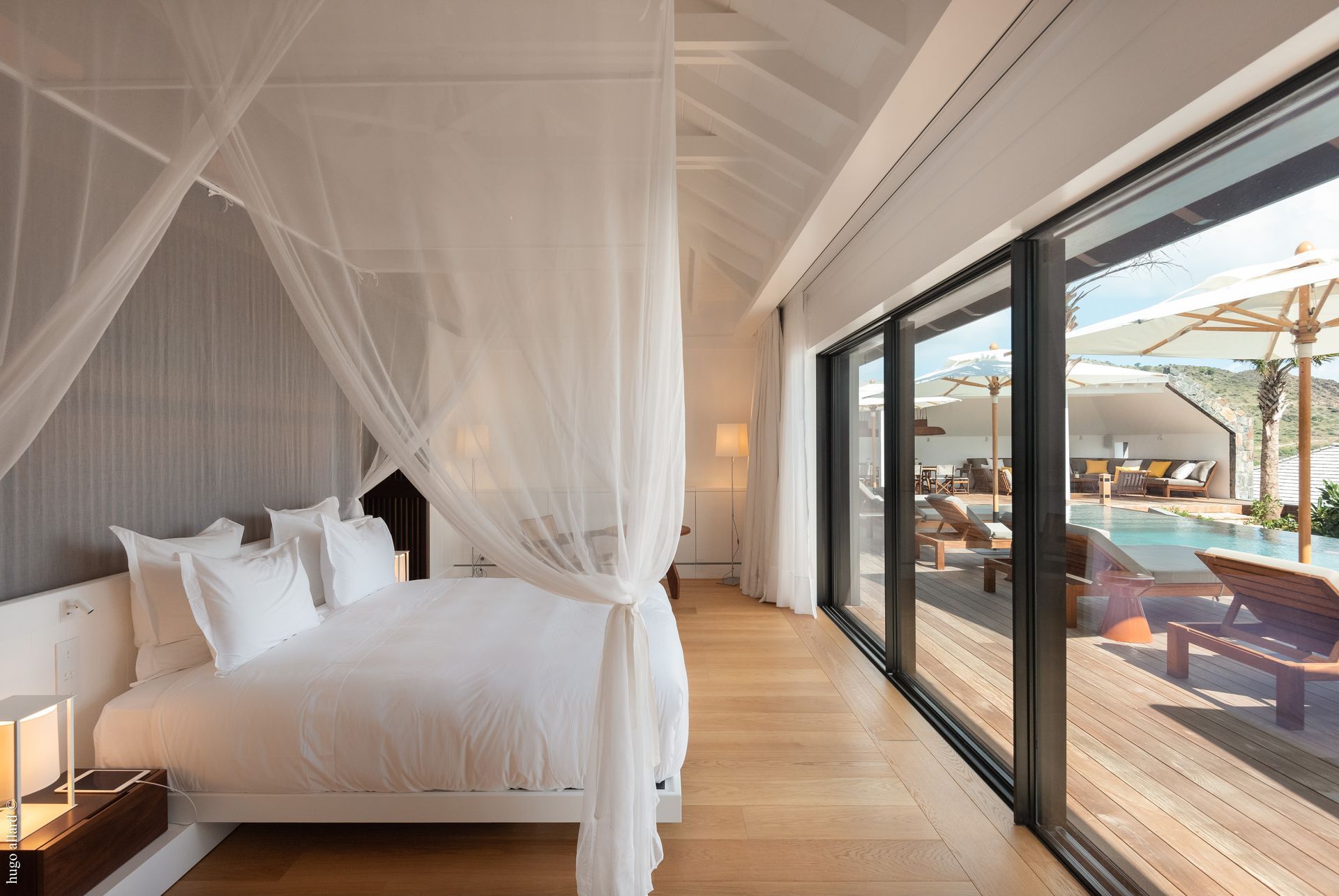 a bedroom with a canopy bed and sliding glass doors