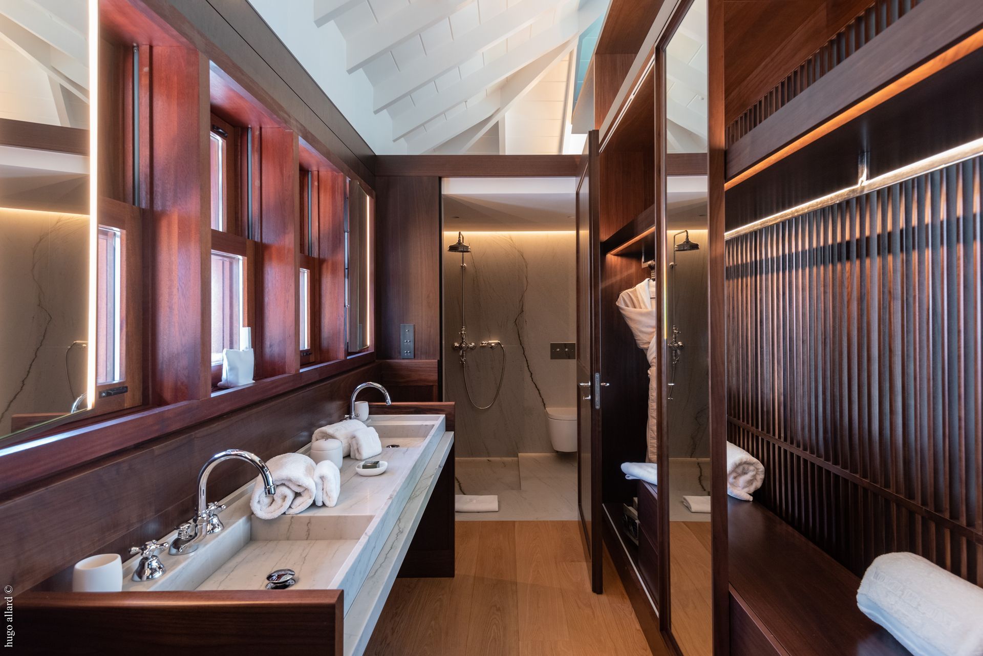 a bathroom with two sinks and a walk in closet
