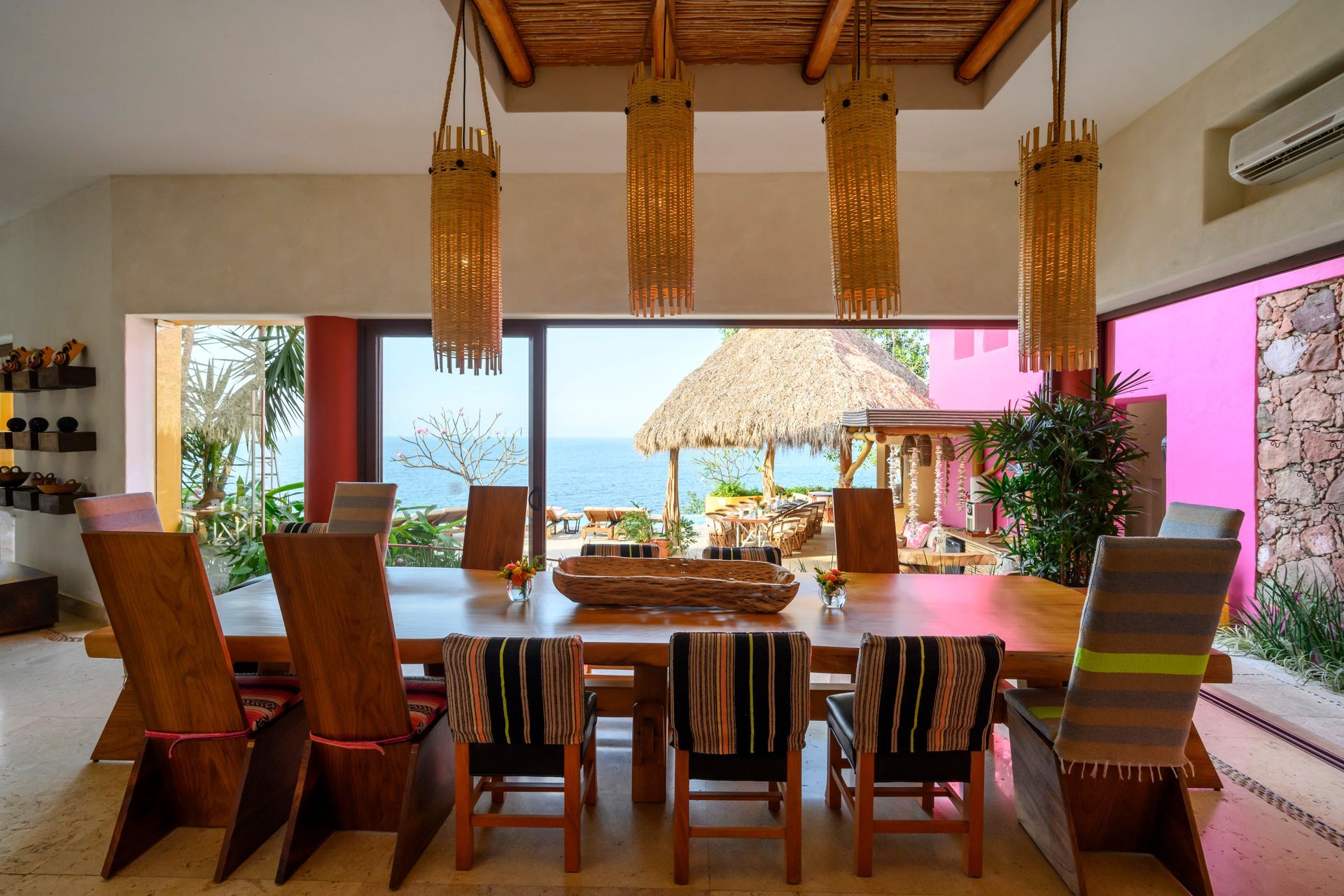 a dining room with a table and chairs and a view of the ocean