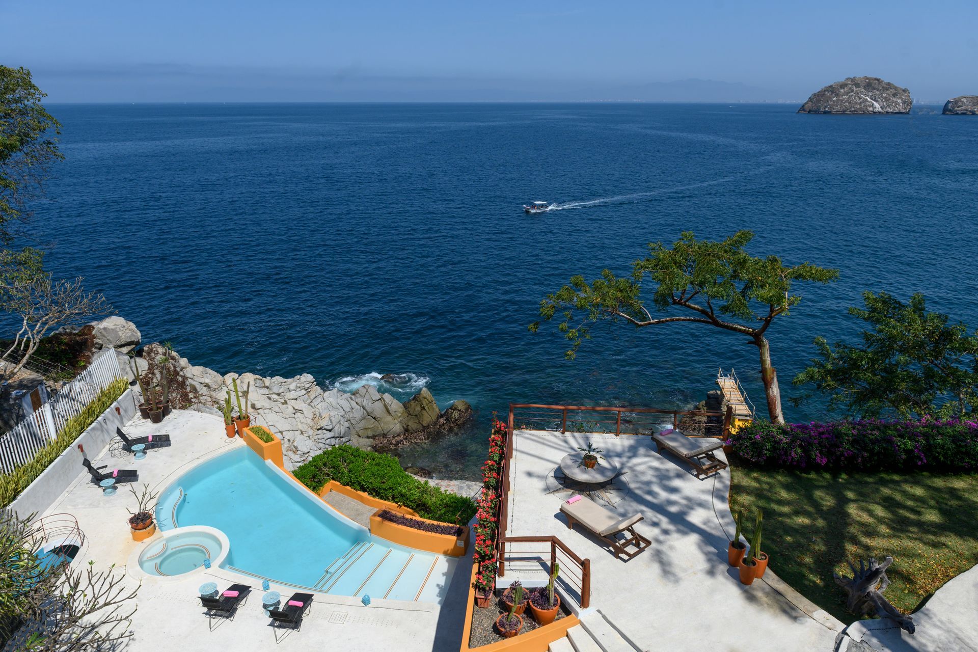 an aerial view of a swimming pool overlooking the ocean 