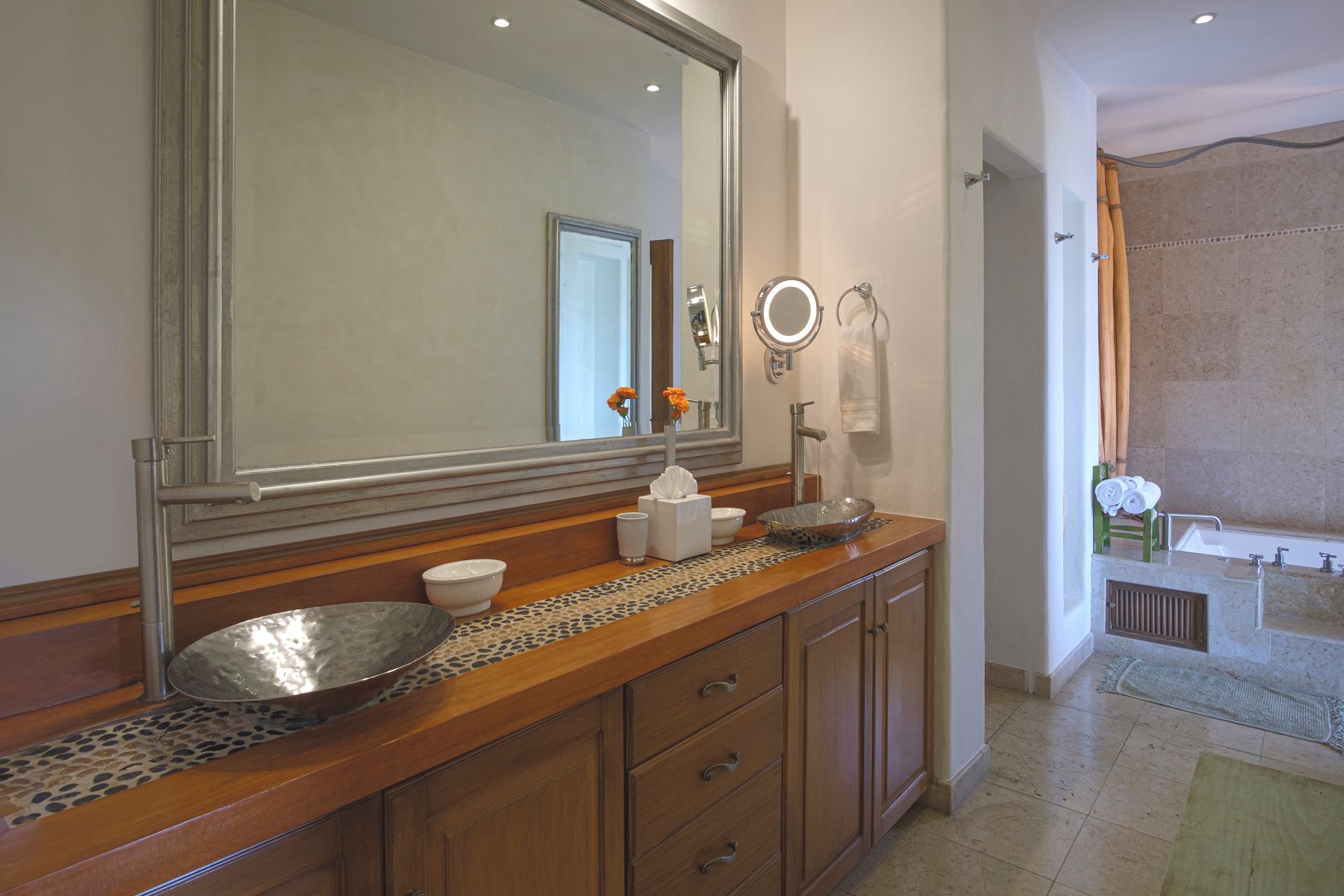 a bathroom with two sinks, a mirror and a tub