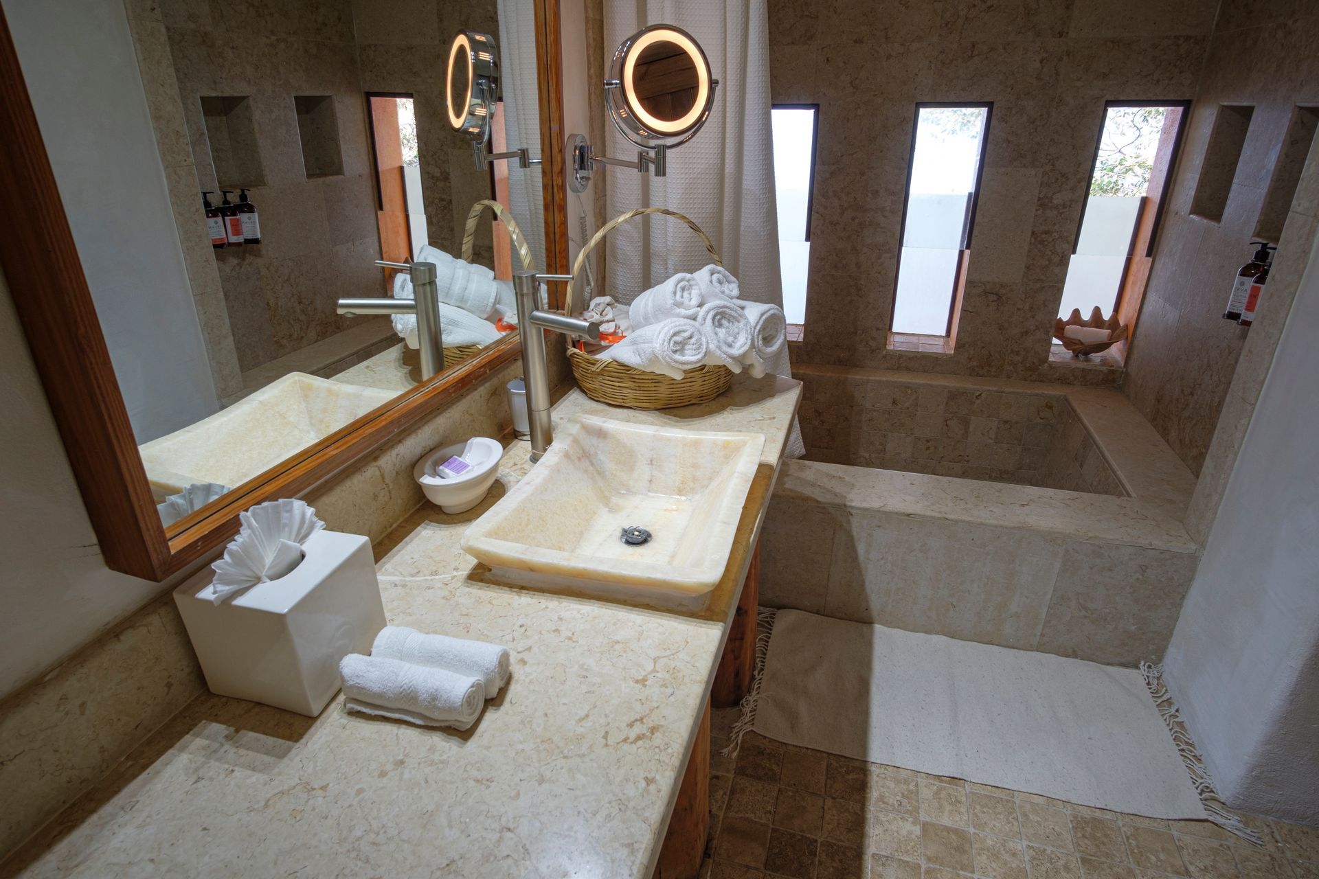 a bathroom with a sink, mirror and tub
