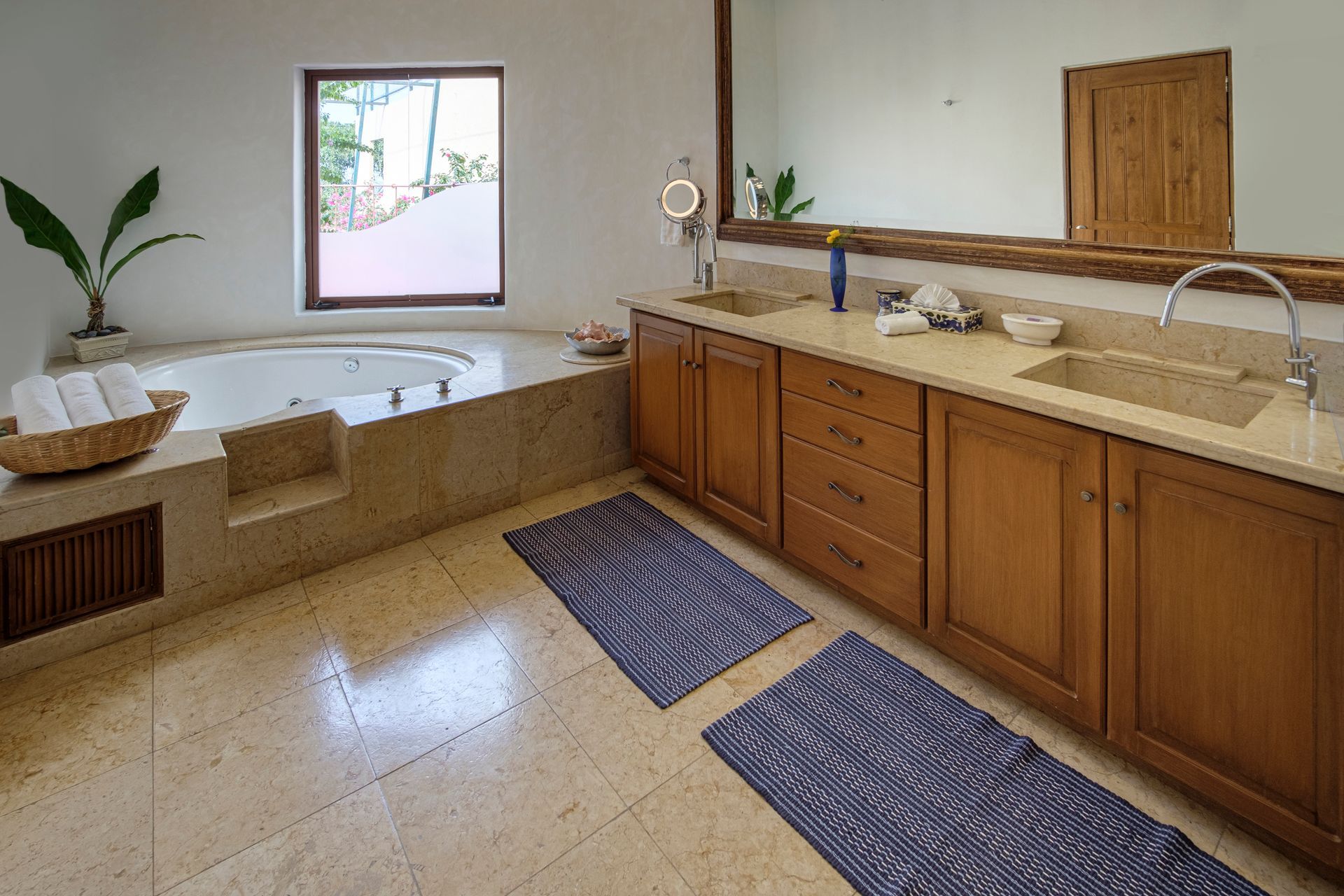 a bathroom with a jacuzzi tub, sink, and mirror