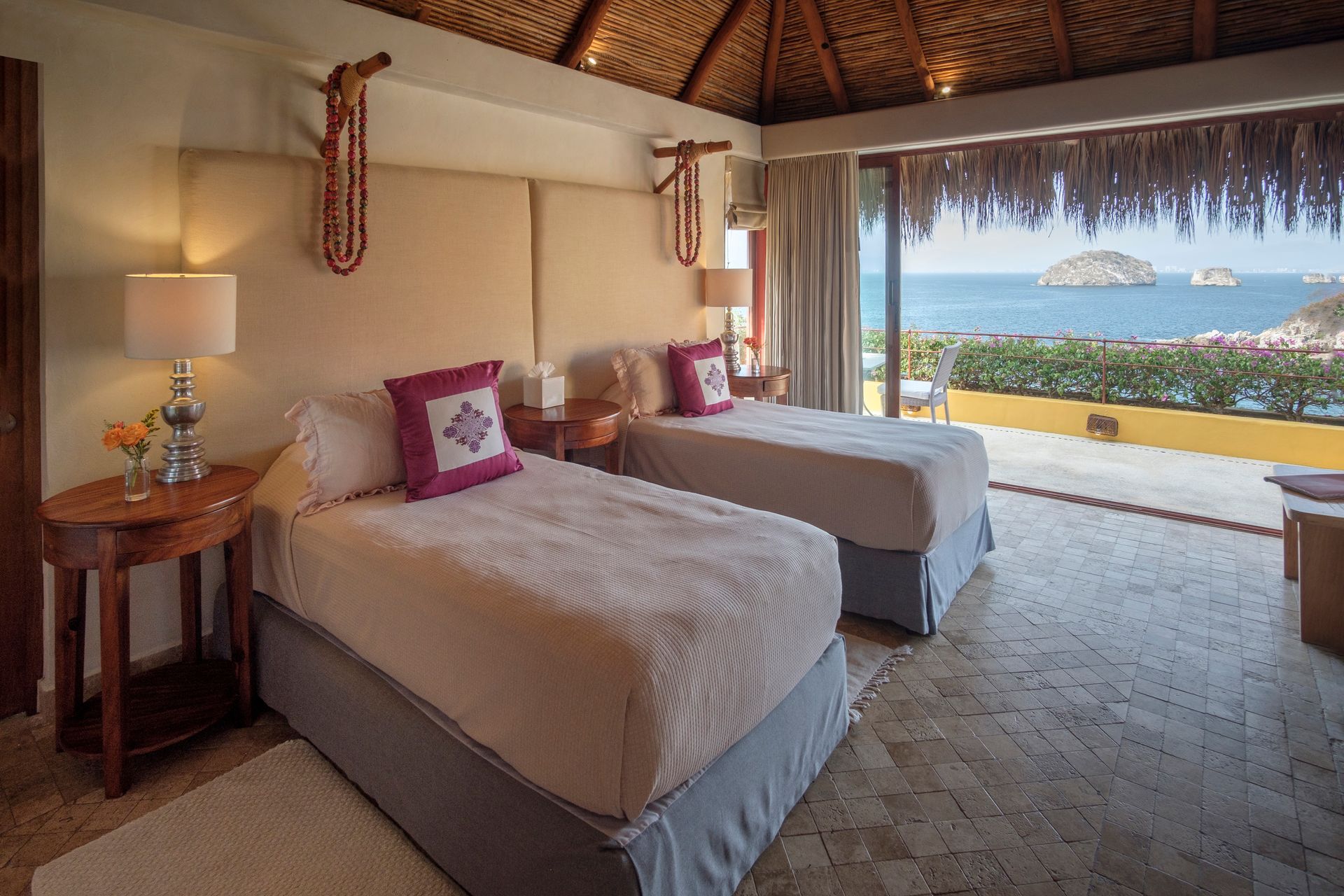 a hotel room with two beds and a view of the ocean