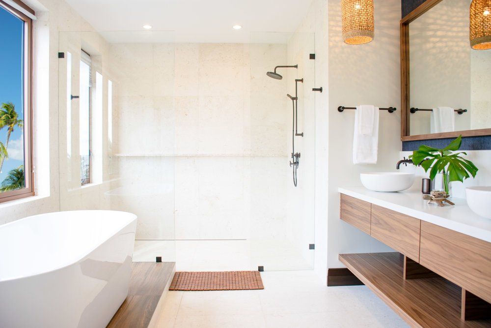 a bathroom with a tub, sinks, mirror and shower