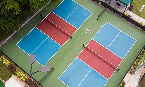 an aerial view of a tennis court with blue and red courts