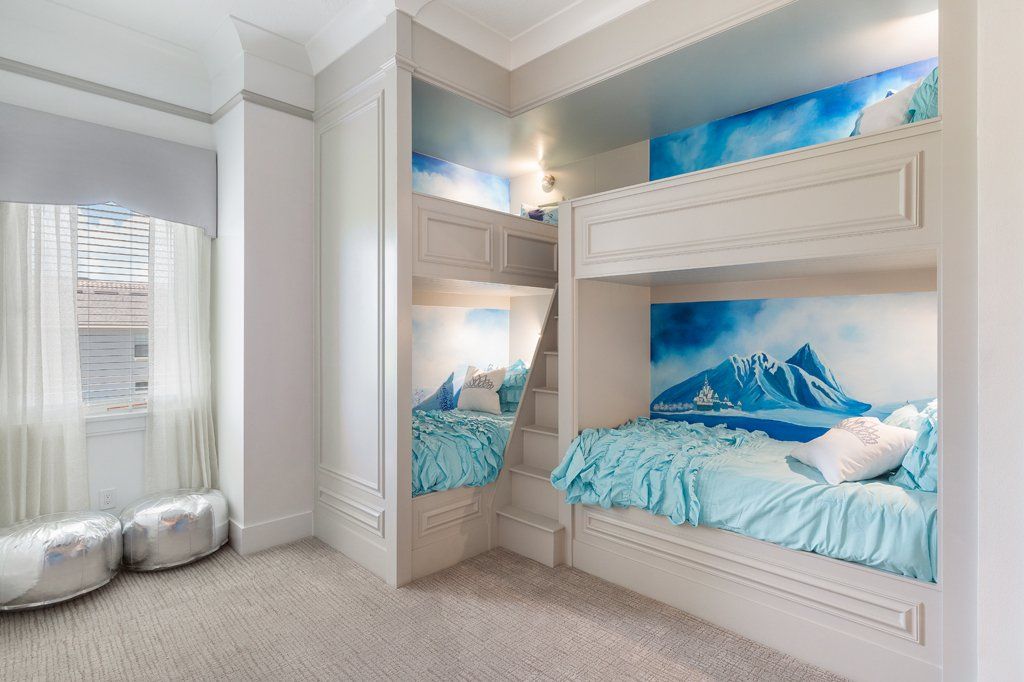 a bedroom with two bunk beds and a window