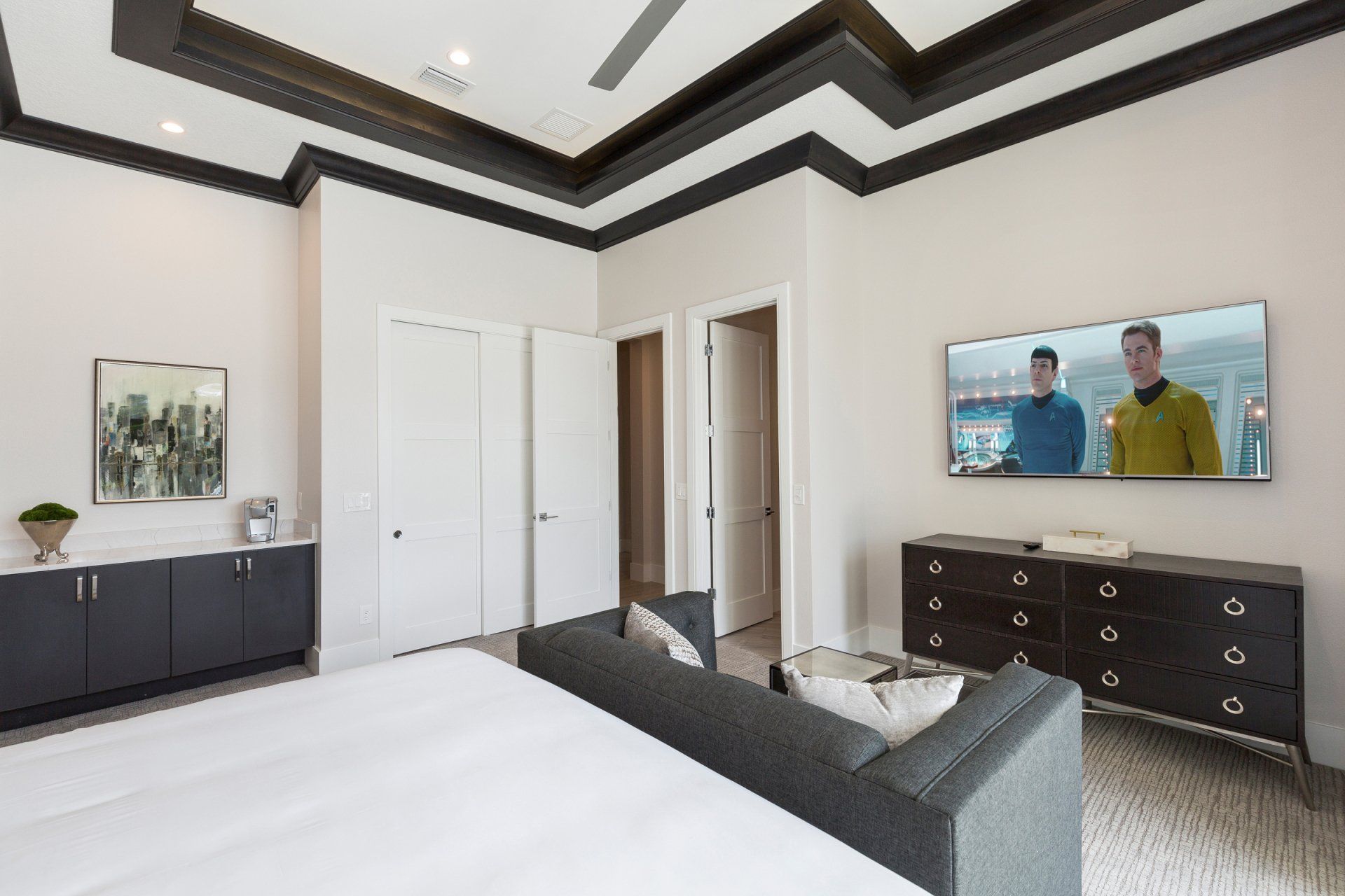 a bedroom with a large flat screen tv on the wall