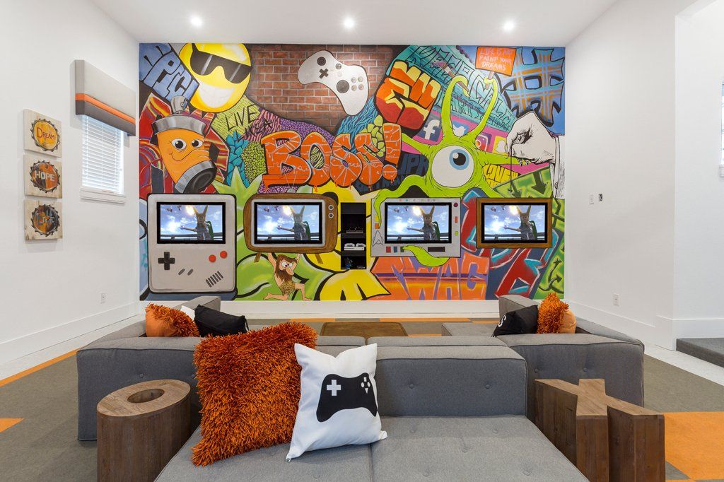 a living room with a couch and a mural on the wall
