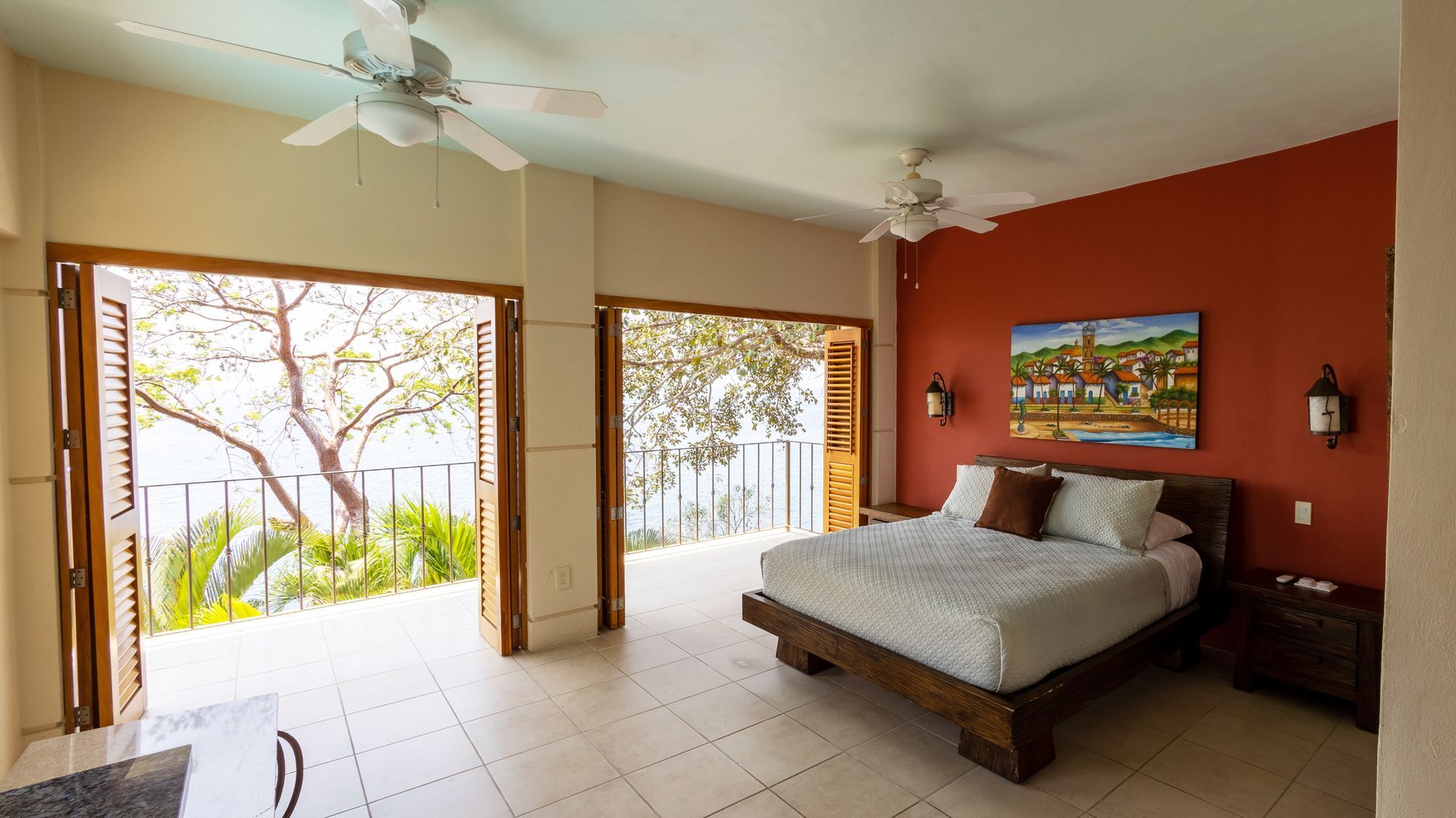 a bedroom with a large bed and a ceiling fan