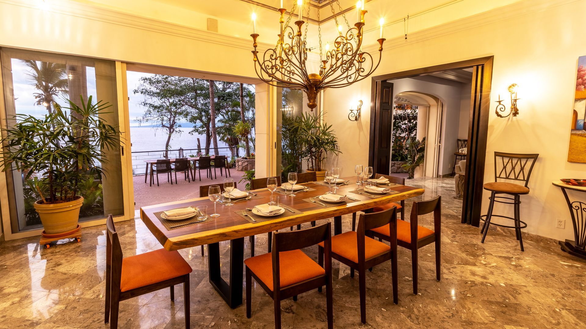 a dining room with a long table and chairs and a chandelier