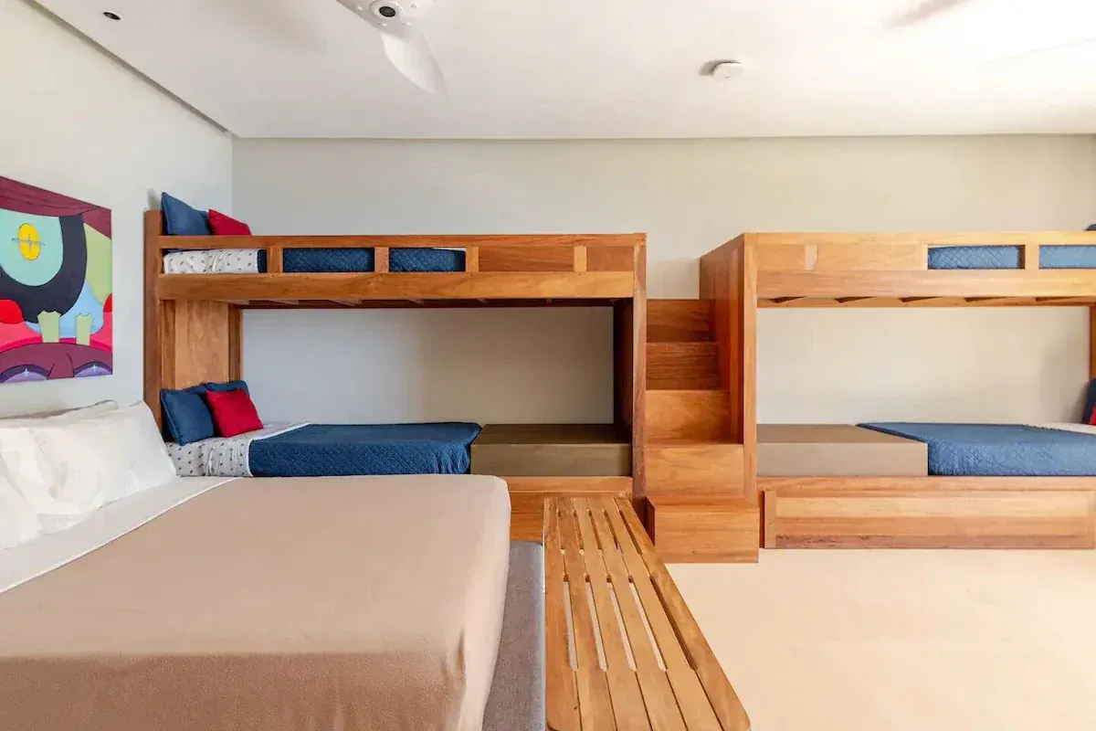 a bedroom with a bed and a television on the wall