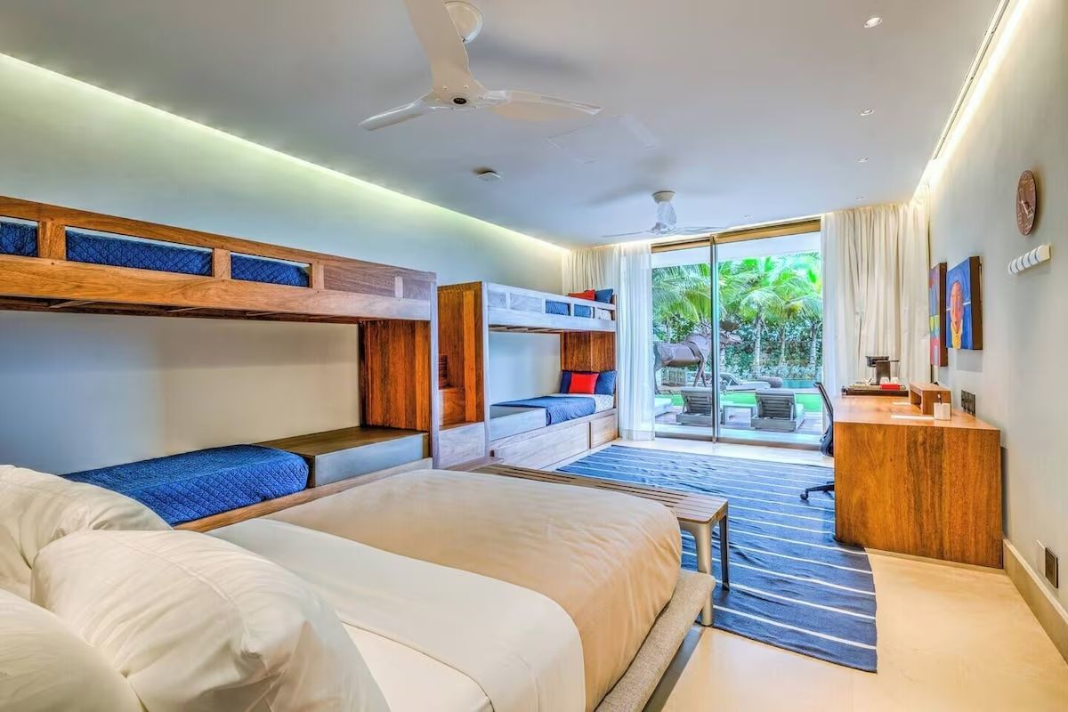 a bedroom with two beds and a ceiling fan