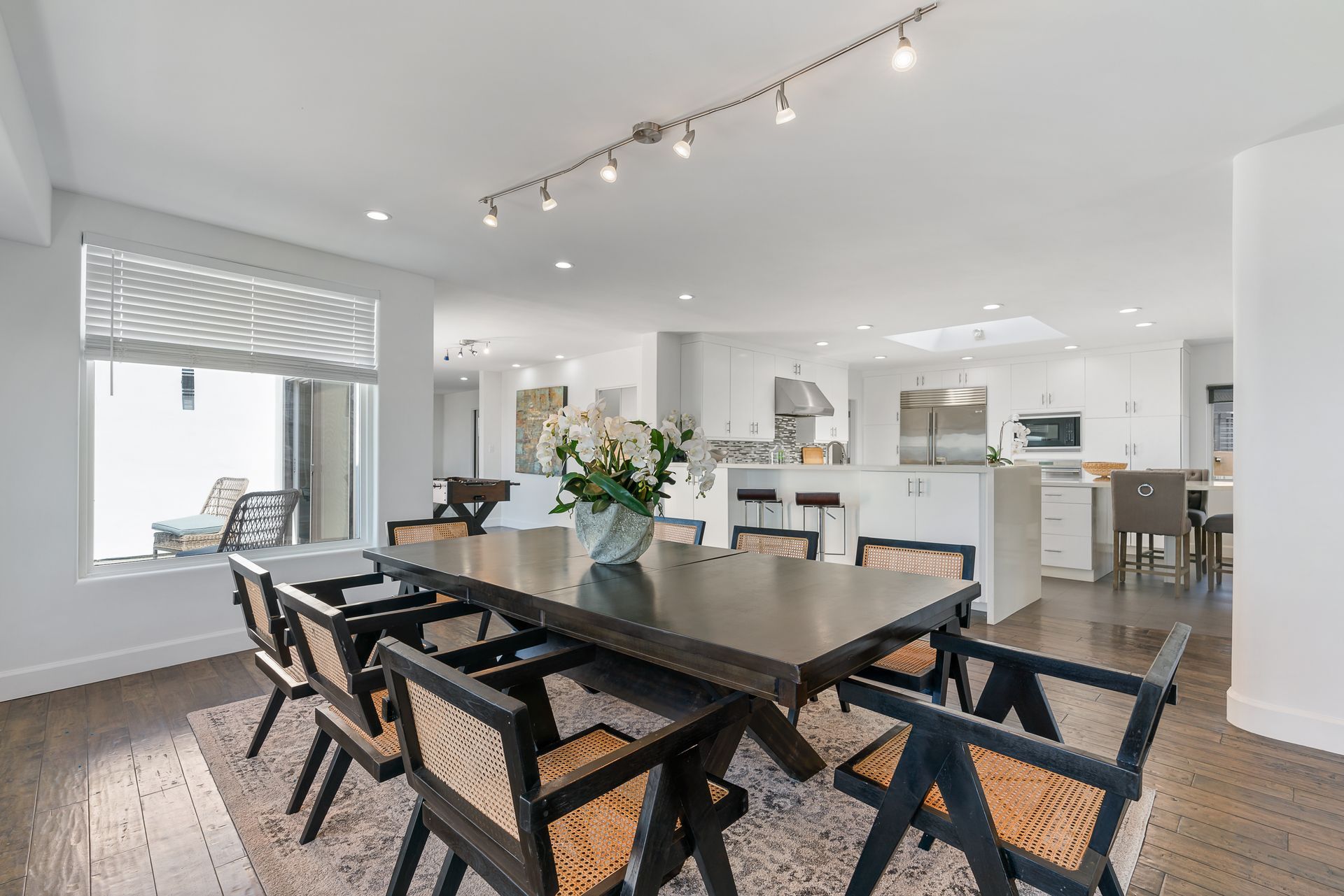 a dining room with a round table and chairs and a rug