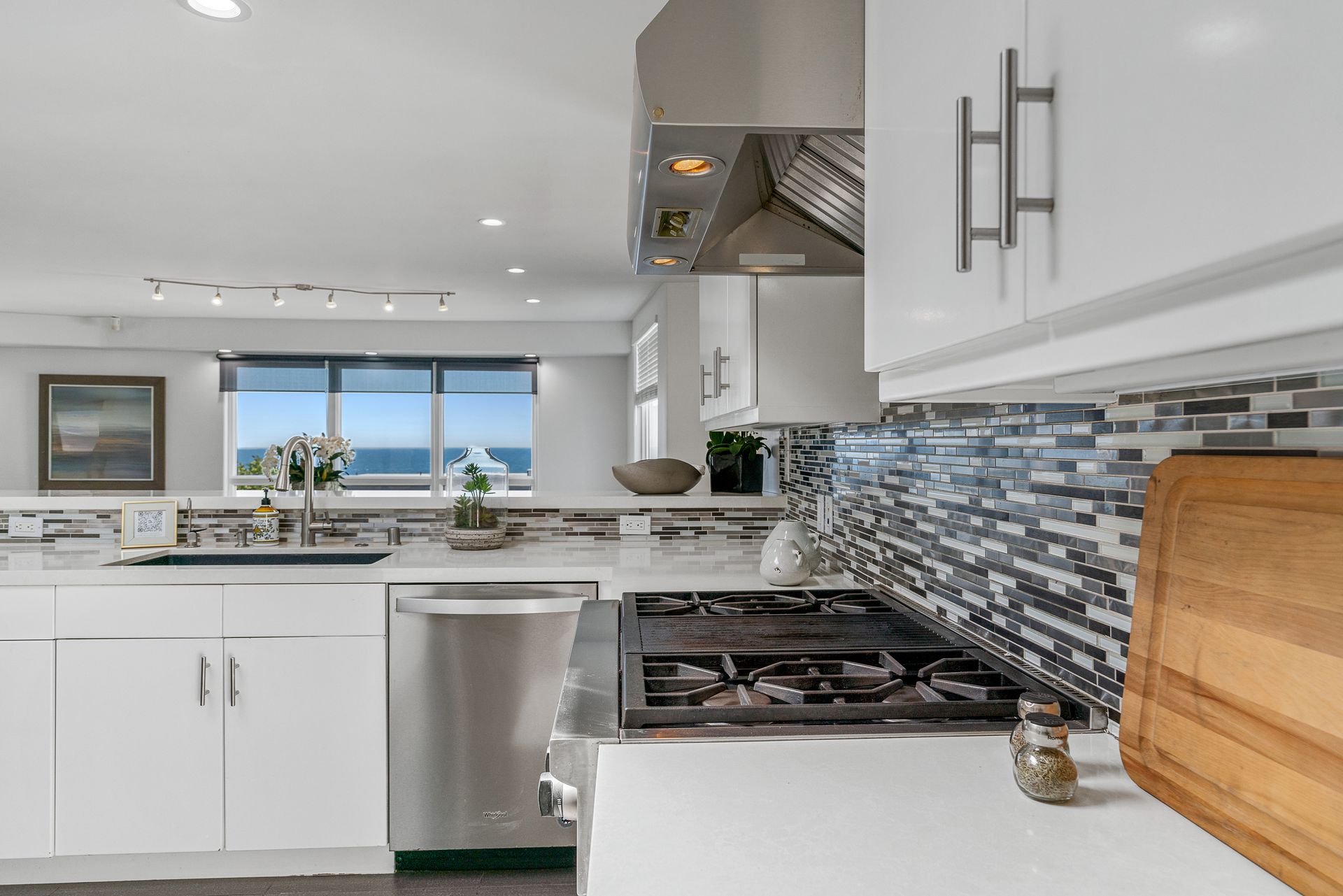 a kitchen with a large island and wooden cabinets