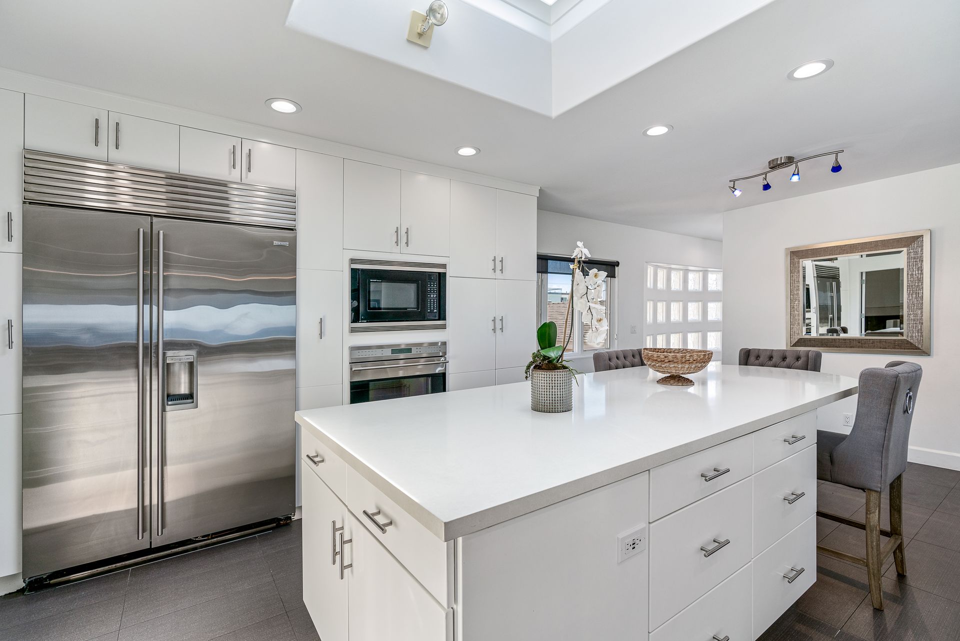 a large kitchen with wooden cabinets and stainless steel appliances