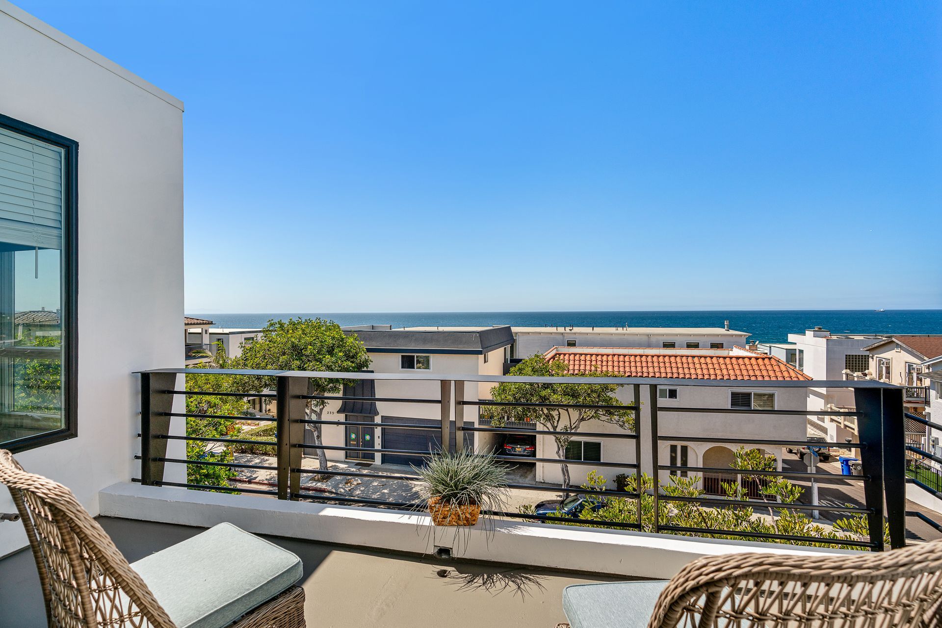 a large wooden deck with a view of the ocean and mountains