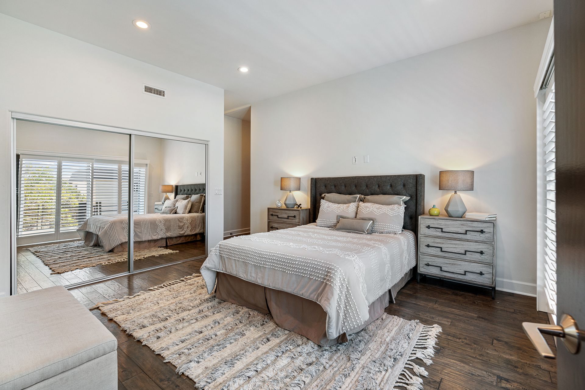 a bedroom with a large bed and a sliding glass door