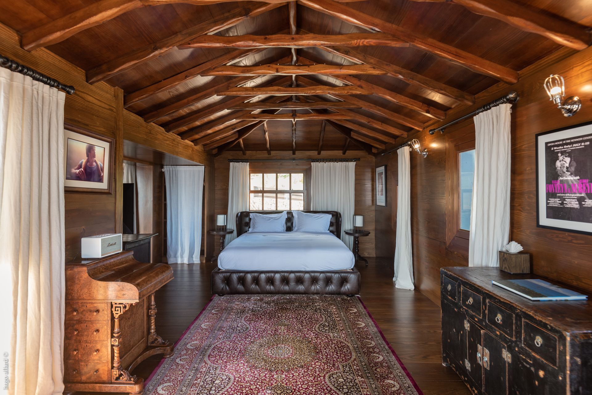 a bedroom with a bed and a piano in it