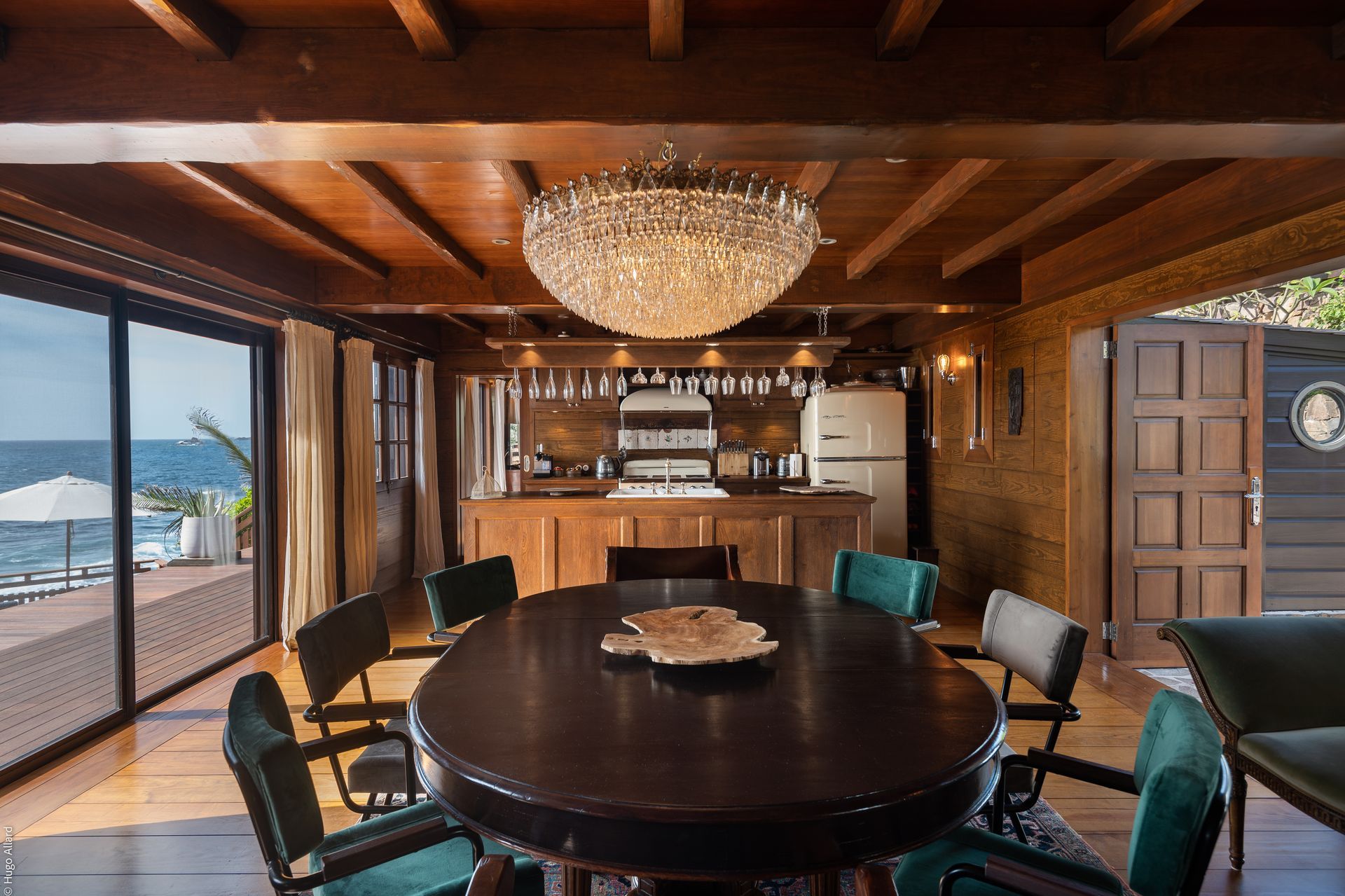 a dining room with a round table and chairs and a chandelier hanging from the ceiling