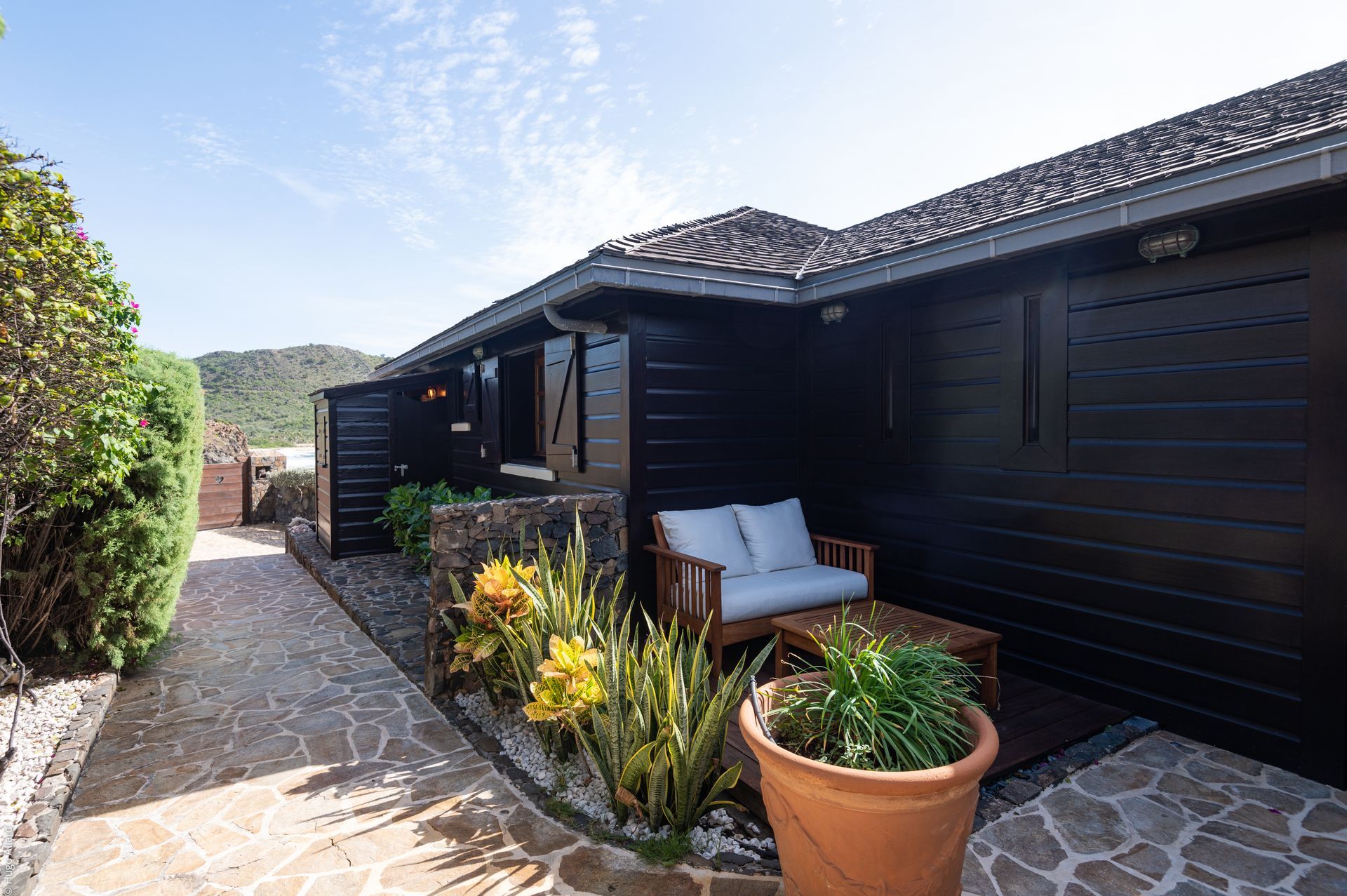 a black house with a couch in front of it