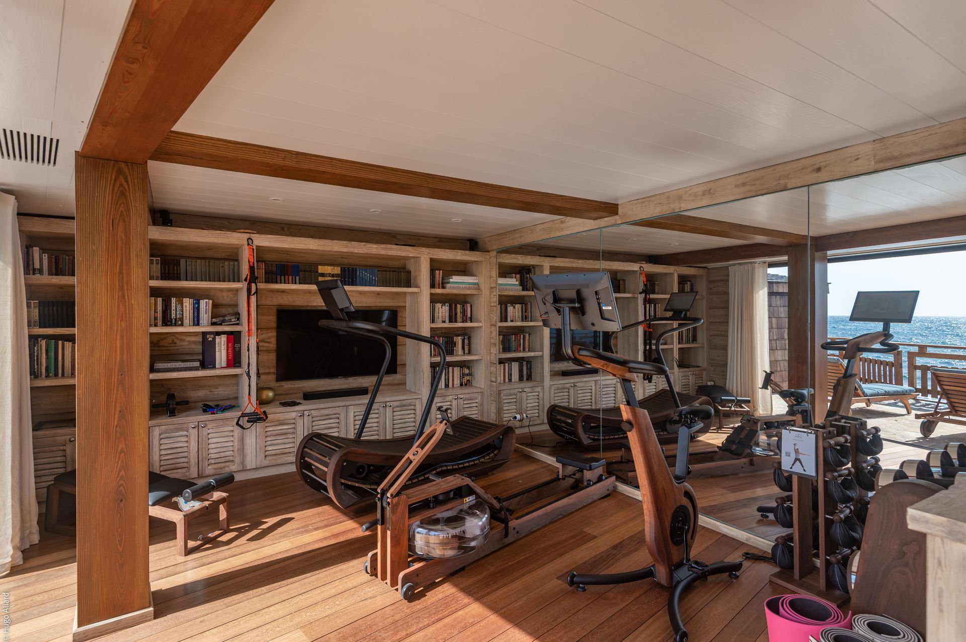 a home gym with a treadmill, exercise bike, and a large mirror