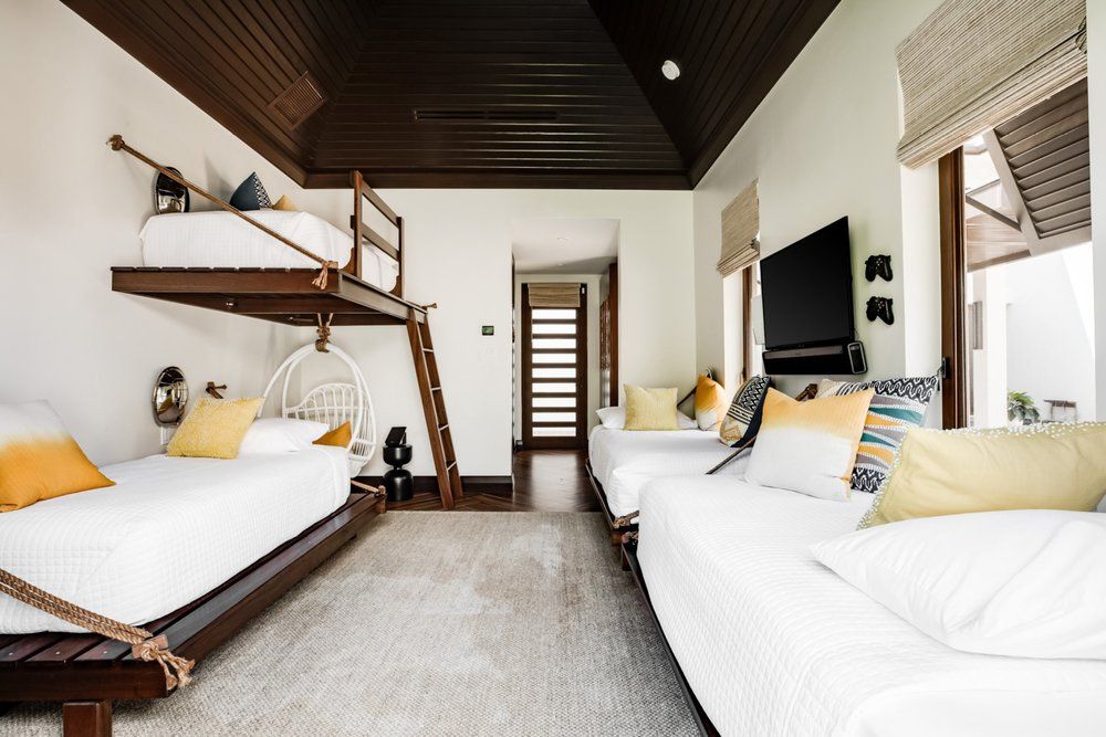 a bedroom with bunk beds and a television on the wall