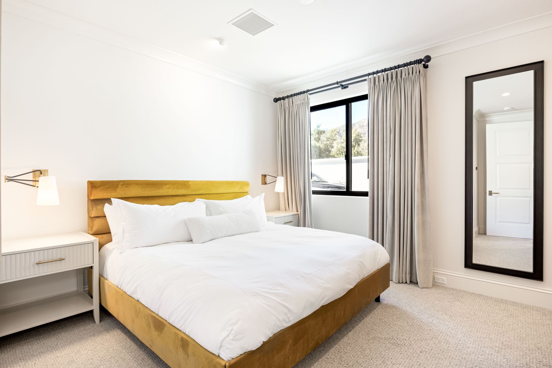 a bedroom with a large bed and a sliding glass door