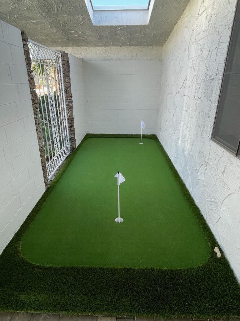 there is a putting green in the middle of a room