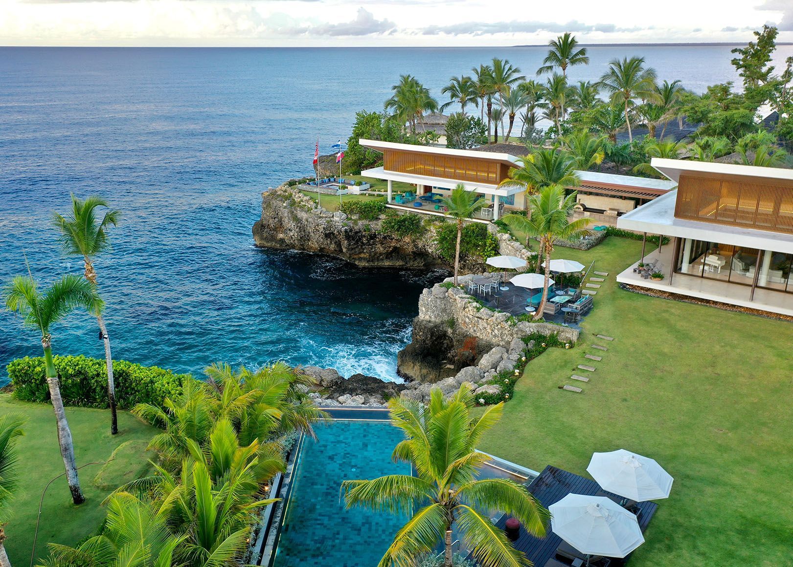 a large house with a large swimming pool in front of it