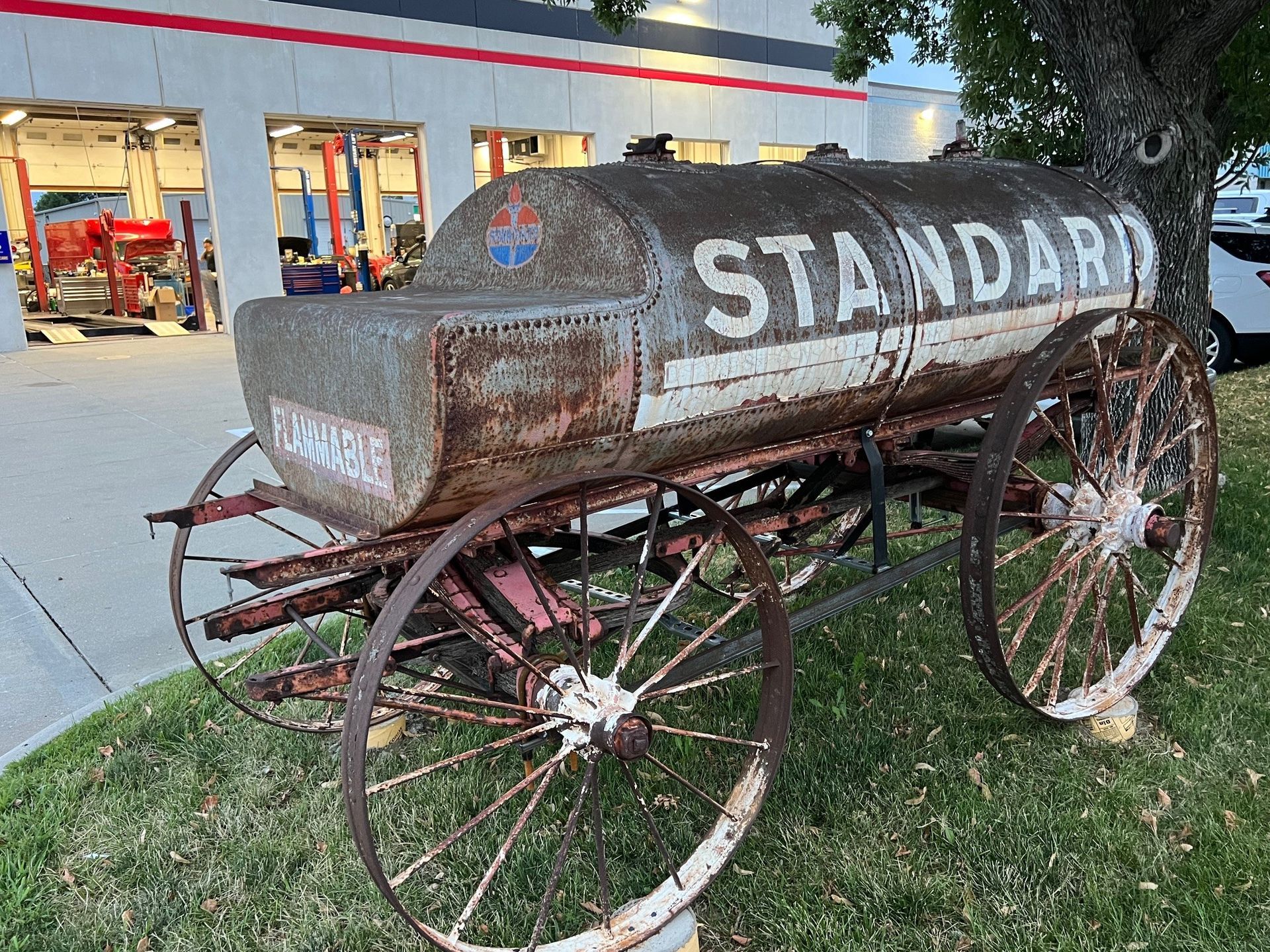 An old Standard Oil wagon on display in front of a building.