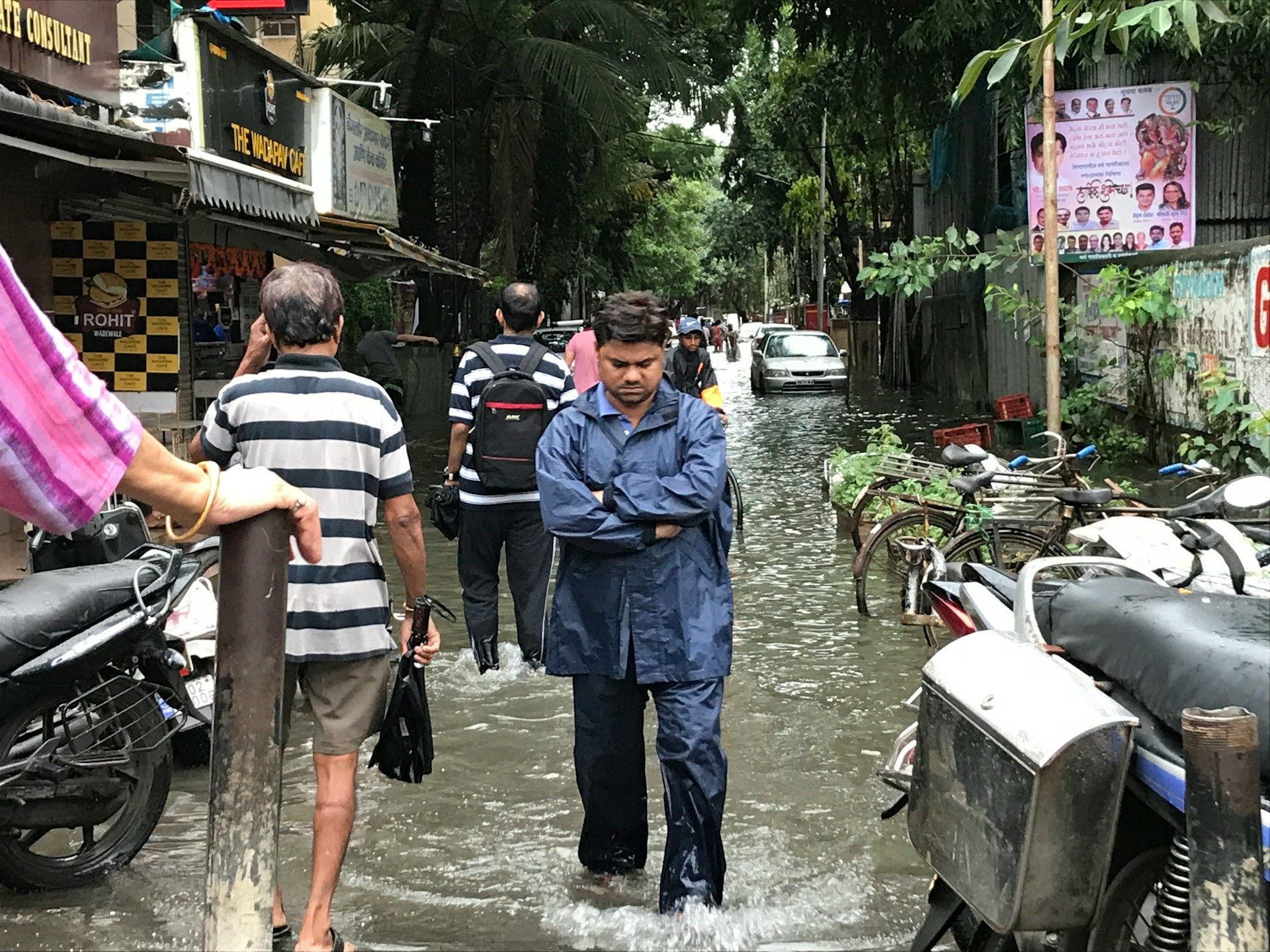 people walking through a flood