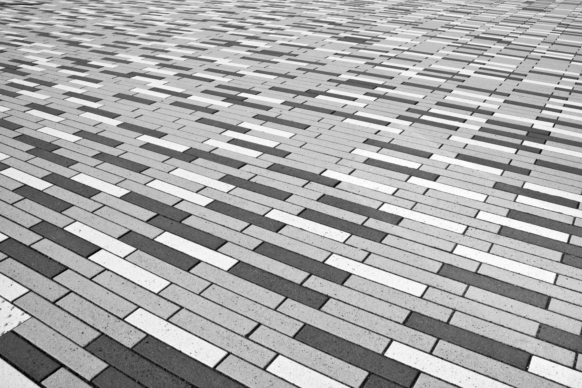 A black and white photo of a brick floor.